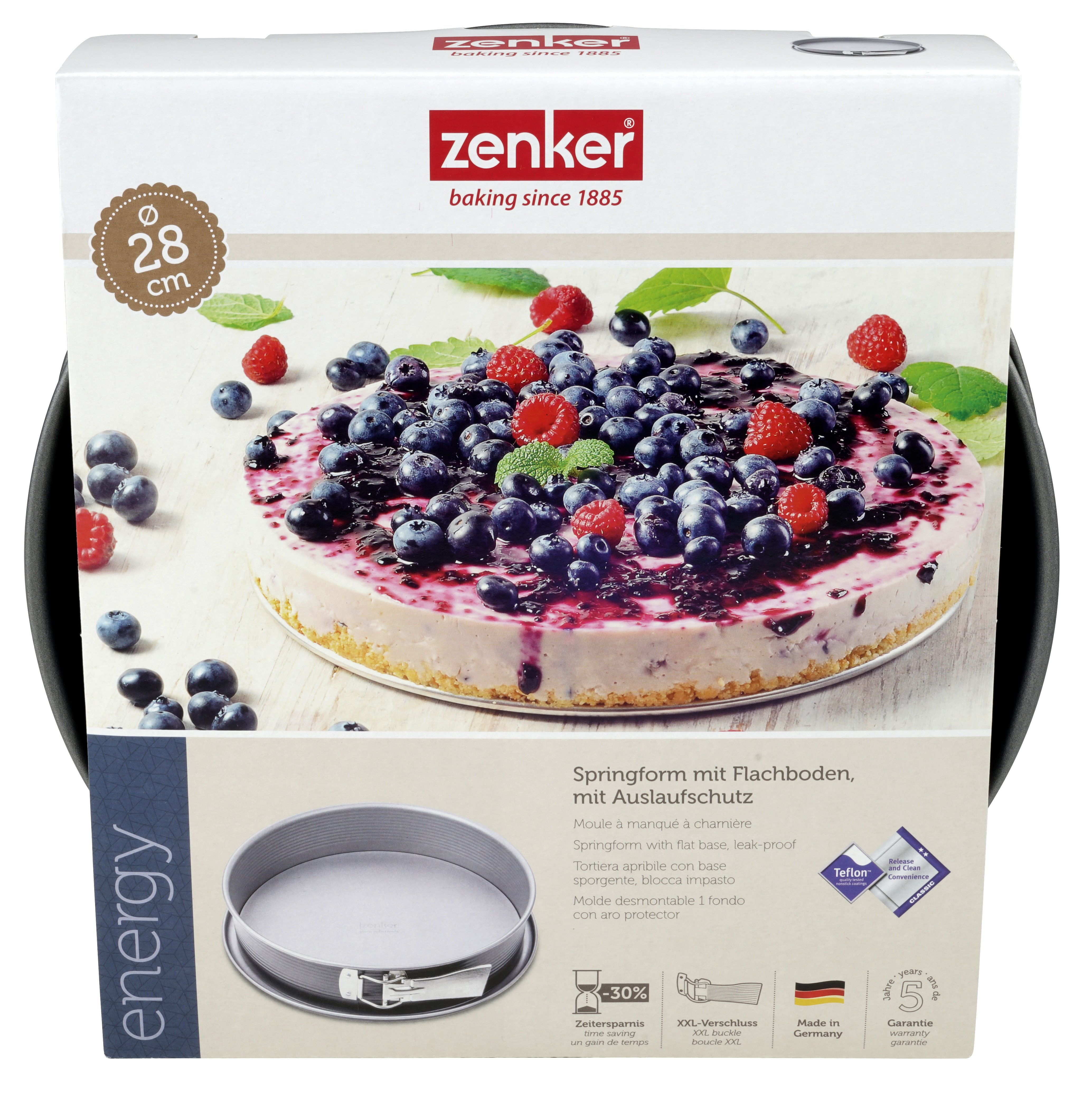 Ein runder Kuchen in einer schwarzen Pfanne, belegt mit Beeren.