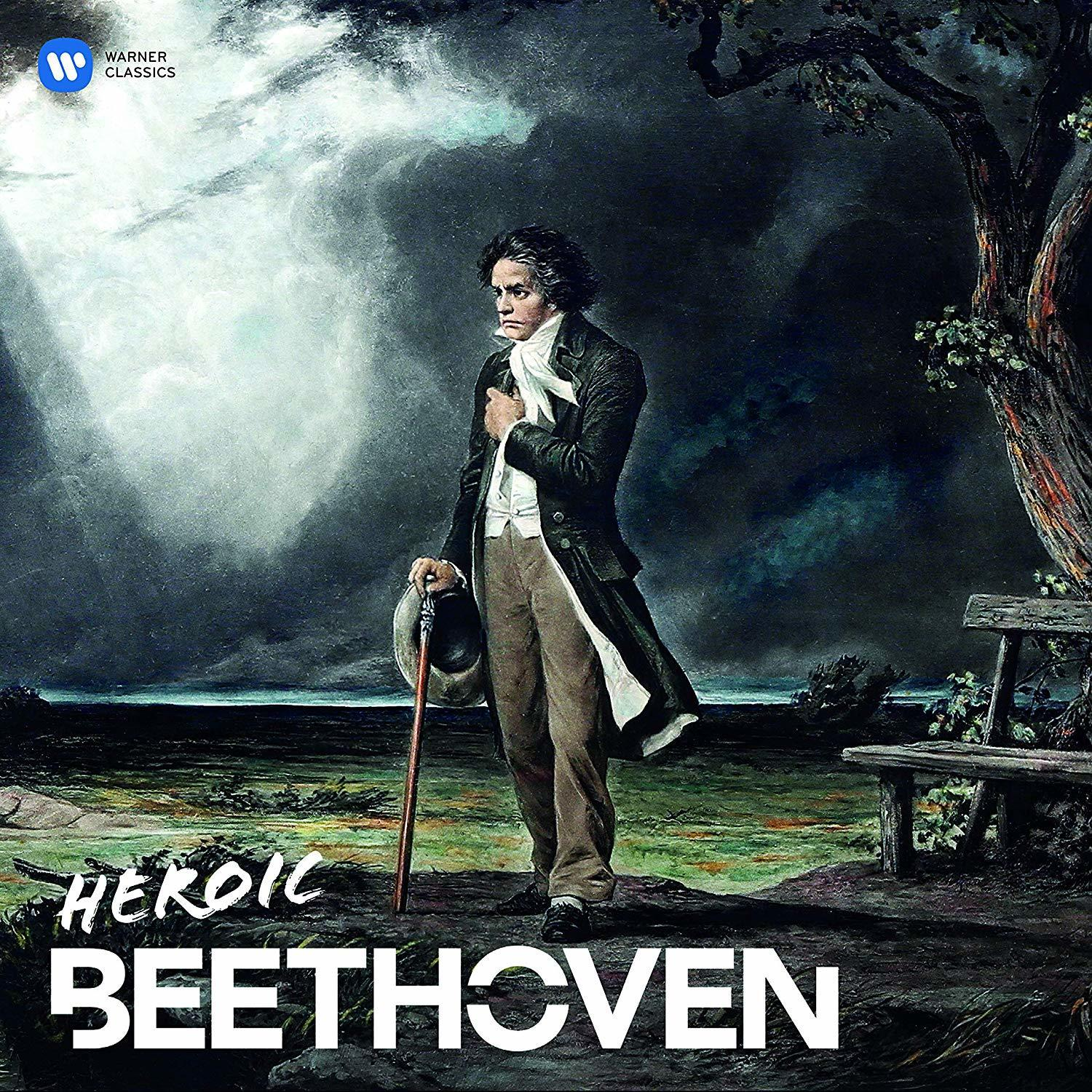 Beethoven a szabadban áll, drámai égbolt alatt. Bot és kalap pihen mellette.