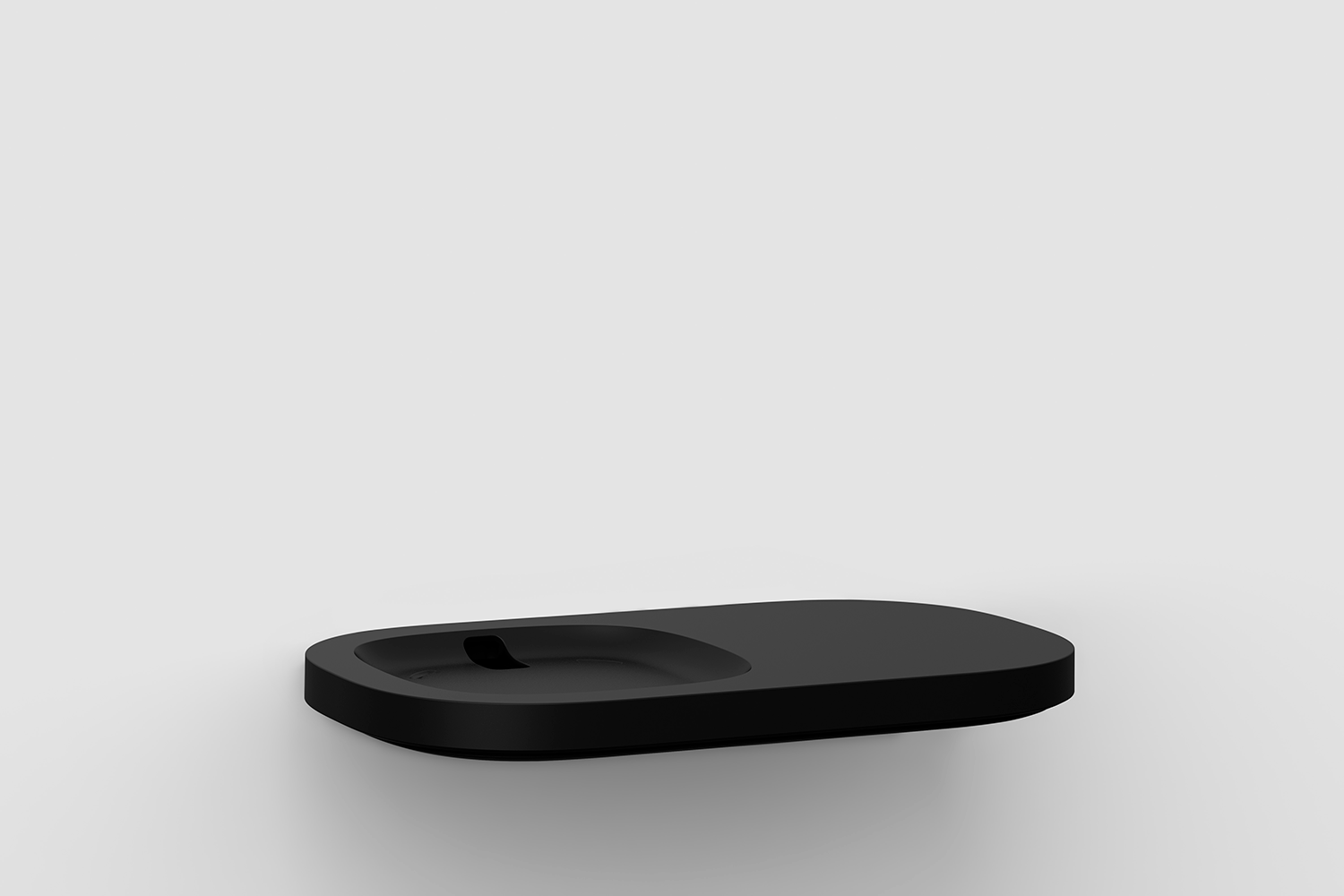 Black soap dish, oval with a small depression in the center.