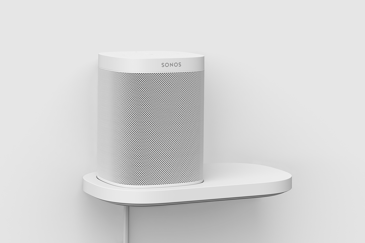 A white Sonos speaker on a white shelf. The speaker sits on a white shelf.