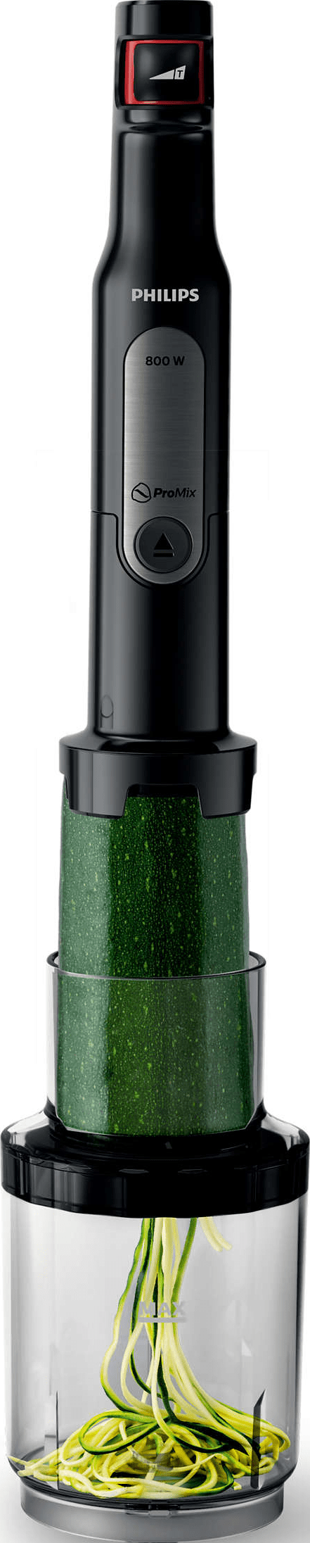 Appareil de cuisine Philips noir avec un légume vert à l'intérieur.