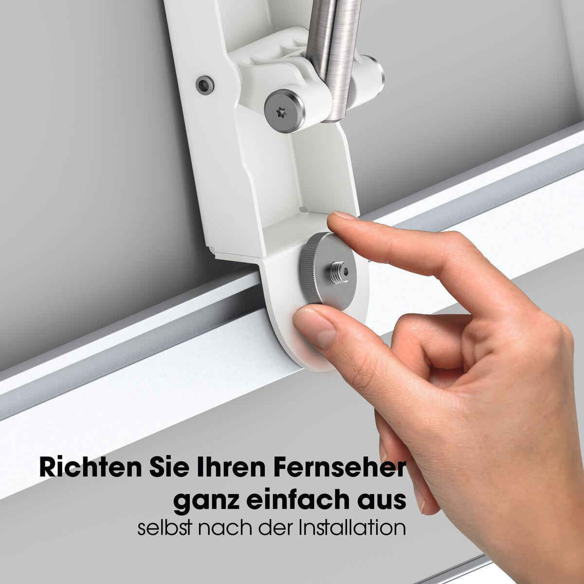 Eine Hand schraubt einen Metallknopf auf ein weißes Gerät.