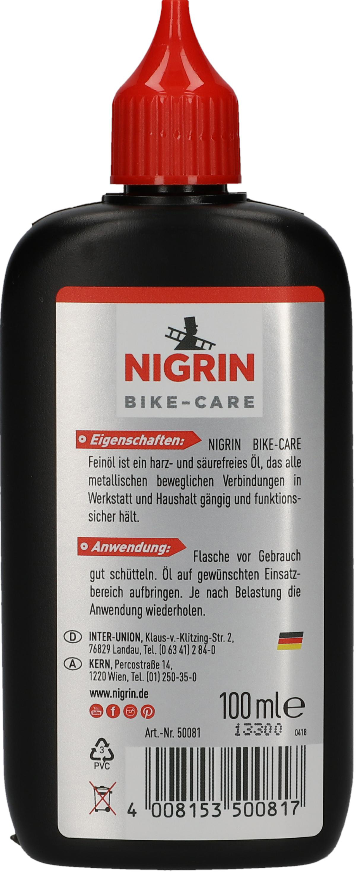Eine schwarze Flasche Nigrin Bike Care mit rotem Deckel, Etikett auf der Rückseite.
