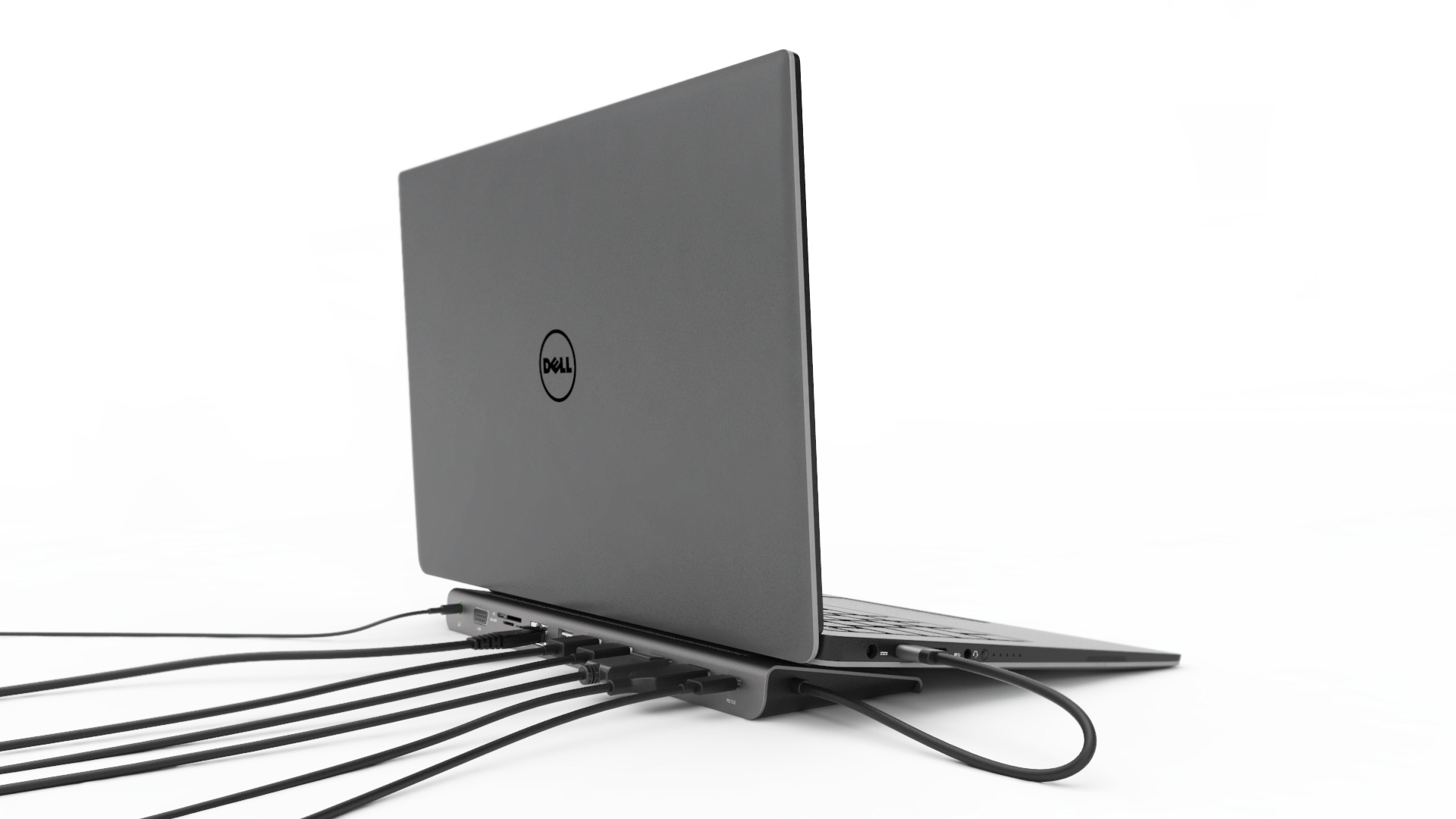 Ein grauer Laptop ist mit einem schwarzen Hub mit mehreren Kabeln verbunden.