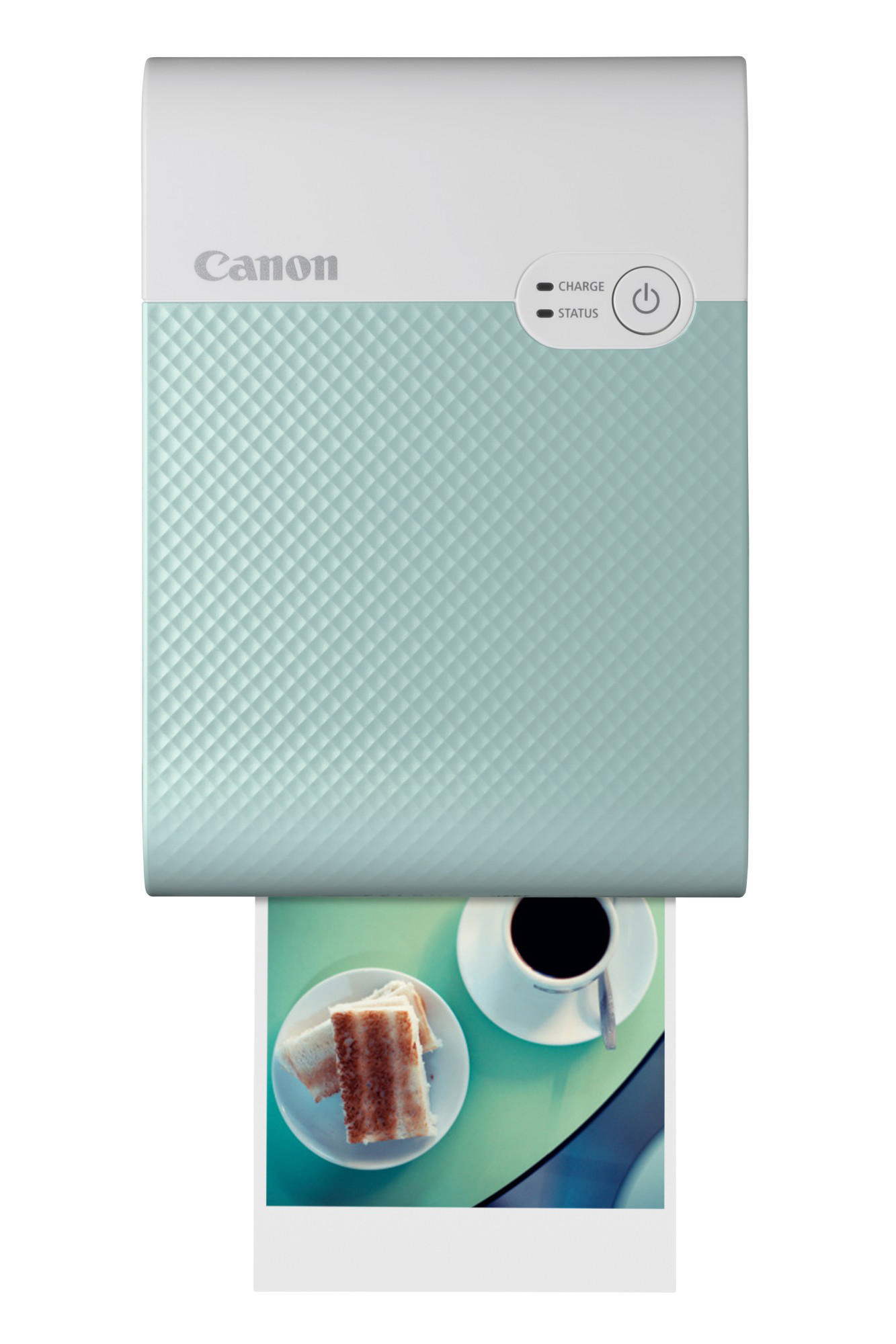 Minzfarbener Canon-Drucker, der ein Foto von Essen auf einem Tisch ausdruckt.