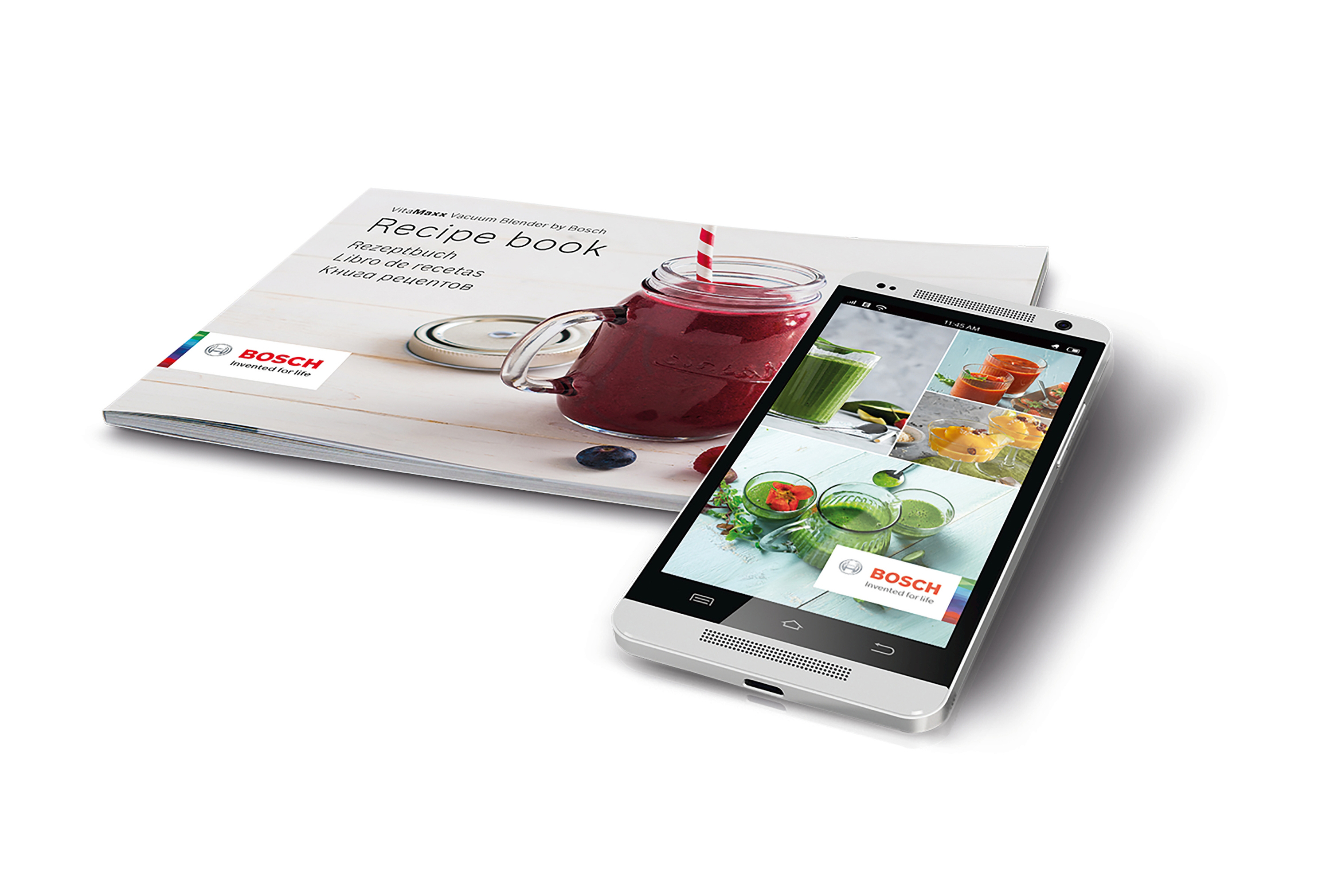 Rezeptbuch, Glas mit rotem Smoothie und Telefon mit ähnlichem Bild.