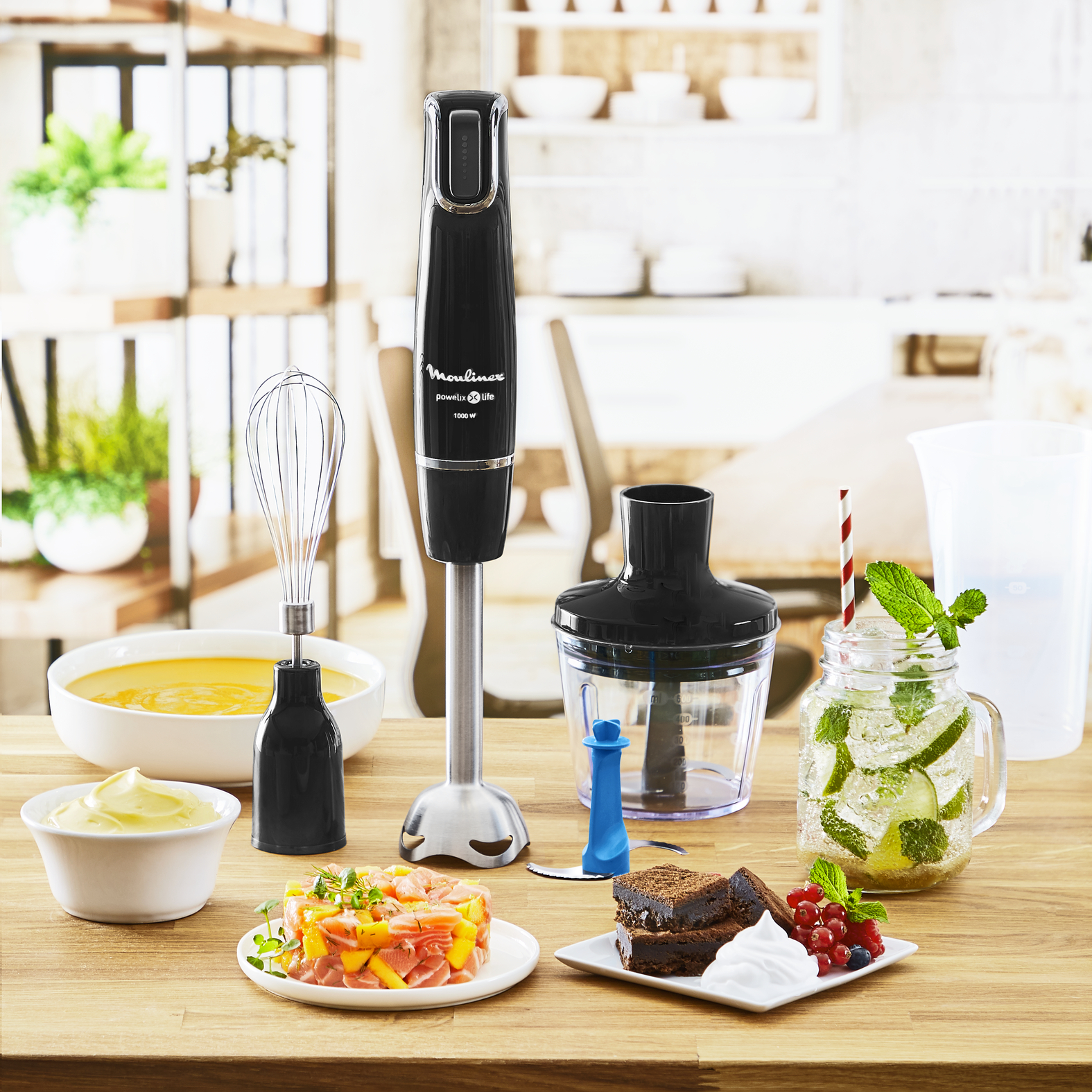 Black Moulinex hand blender with accessories, food ingredients.