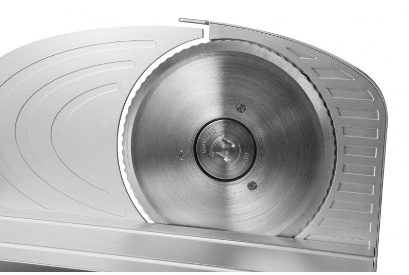 Close-up of a silver meat slicer with a circular blade.
