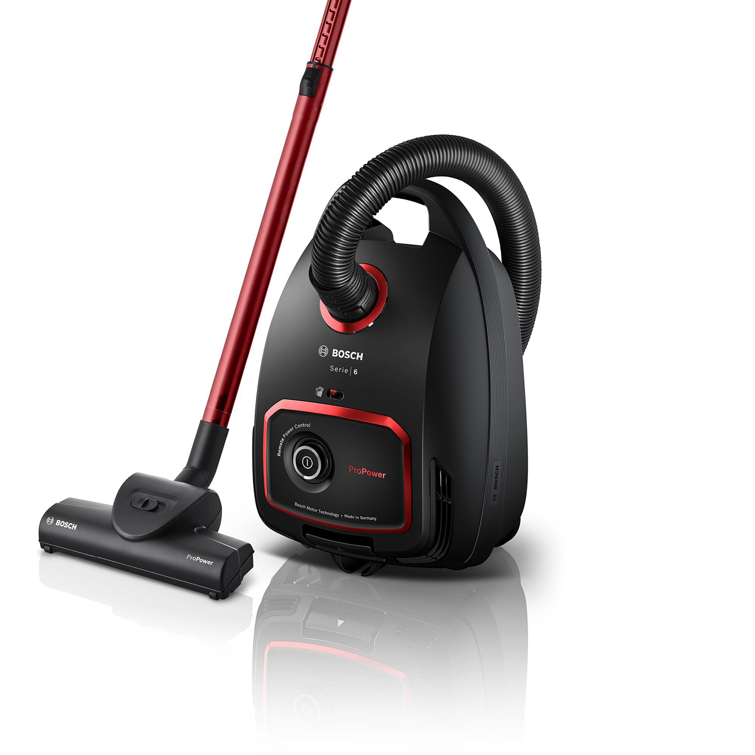 Black and red Bosch vacuum cleaner with attachments and a red pole.