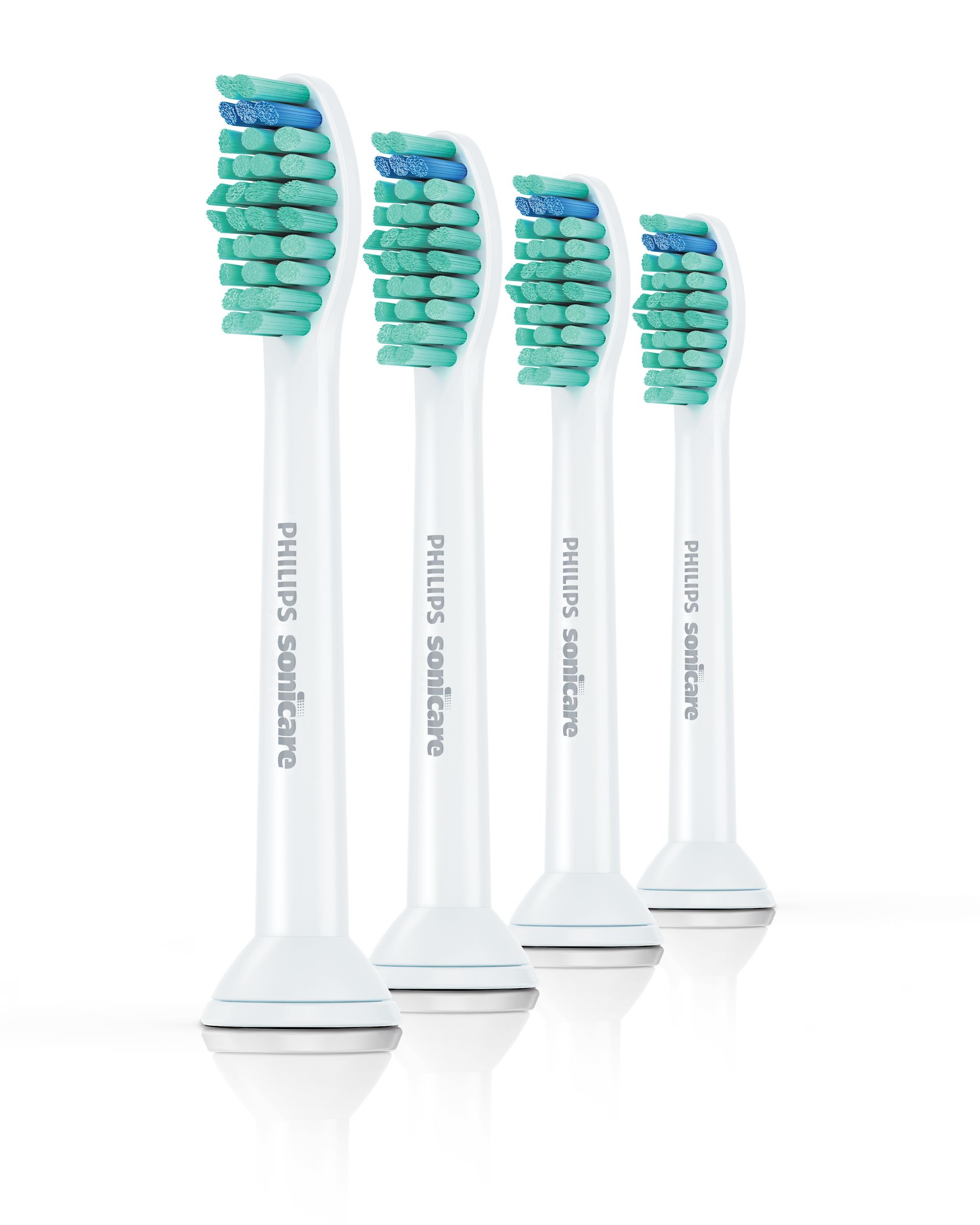 Vier weiße Philips Sonicare Zahnbürstenköpfe.