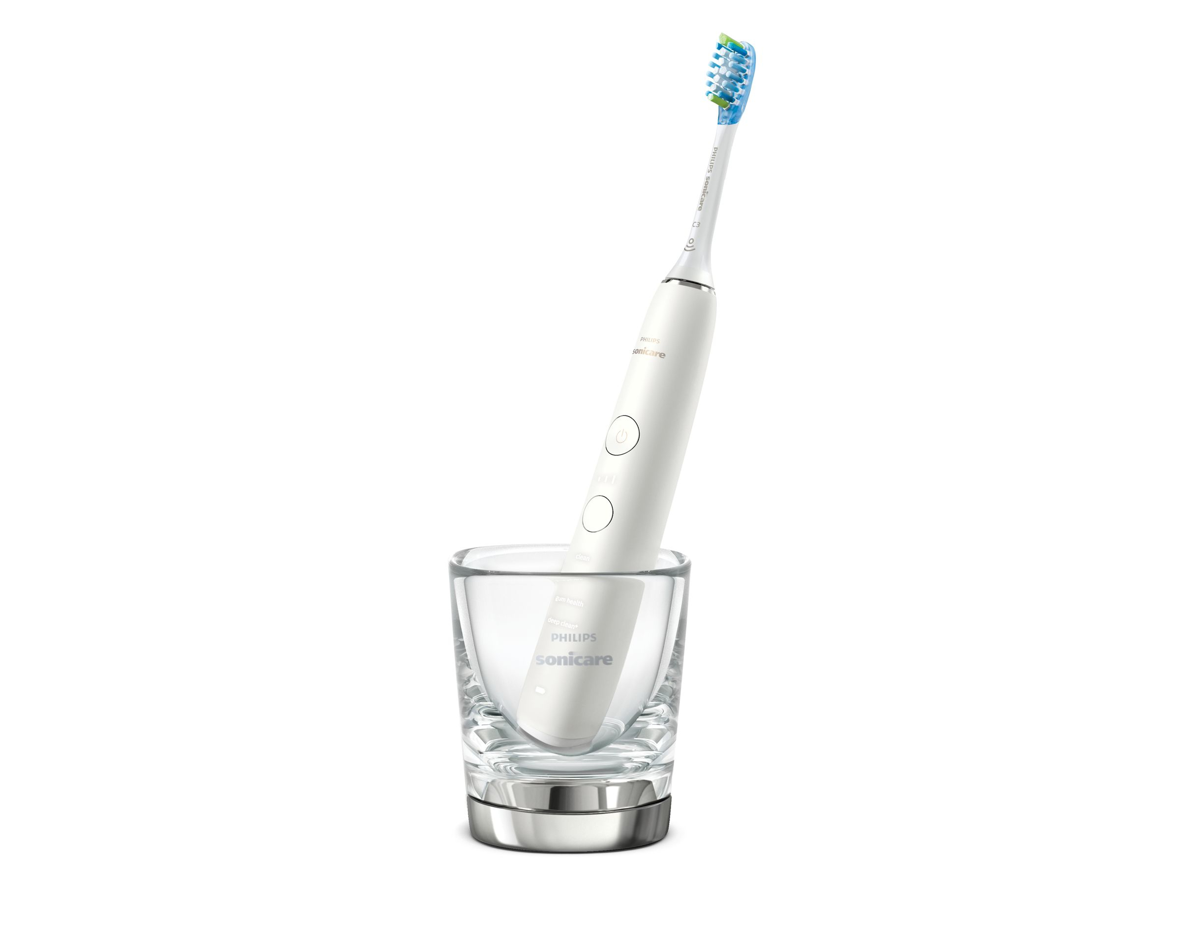 Eine weiße elektrische Zahnbürste in einem Glas auf silbernem Sockel. Der Kopf ist blau und grün.