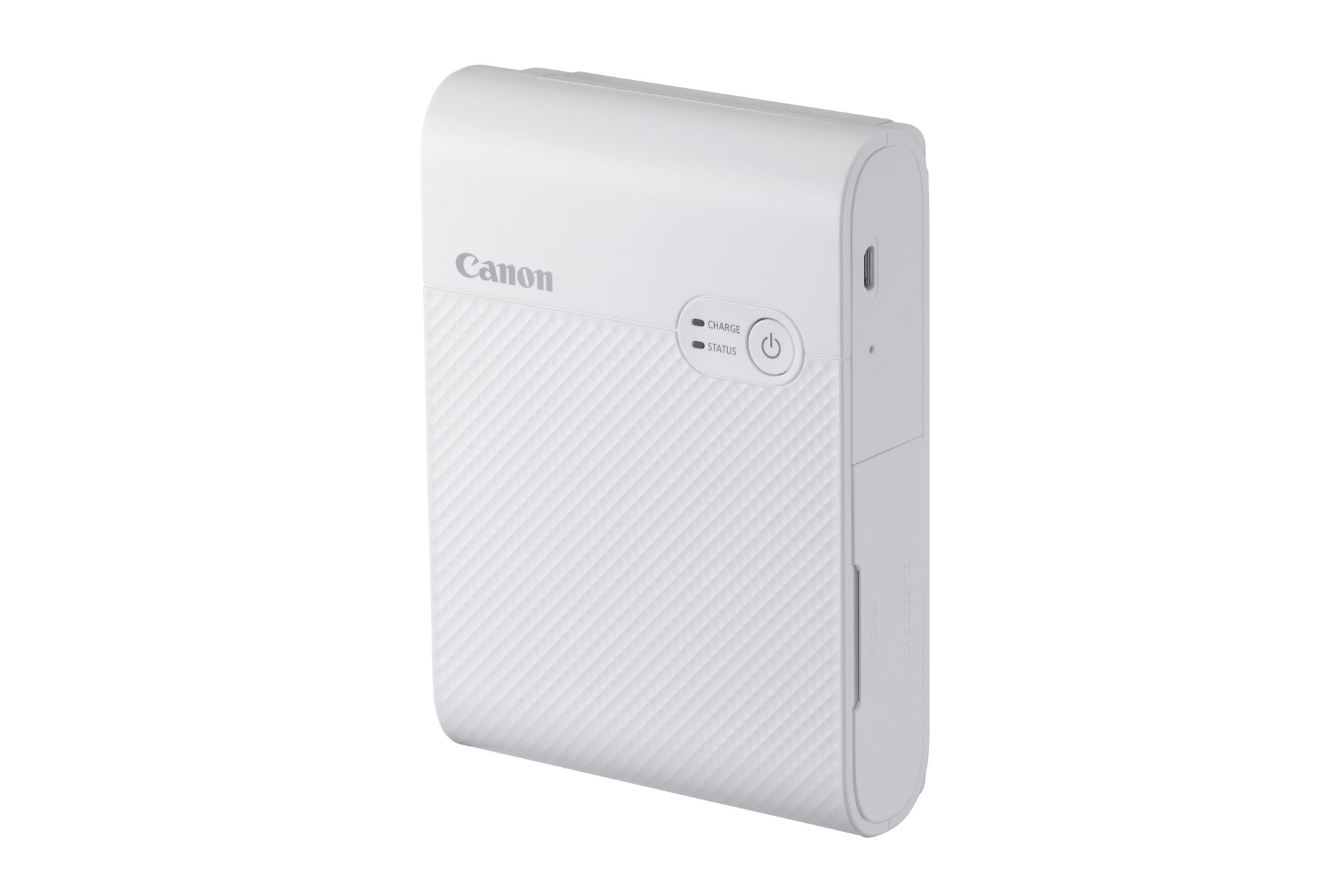 A white Canon Selphy photo printer with a power button.