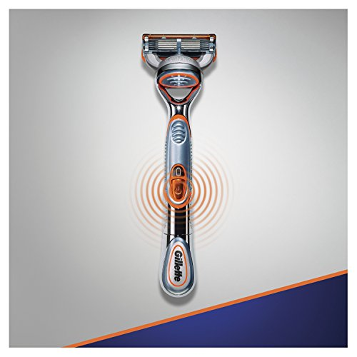 Una maquinilla de afeitar Gillette con un mango naranja y plateado, sobre un fondo gris.