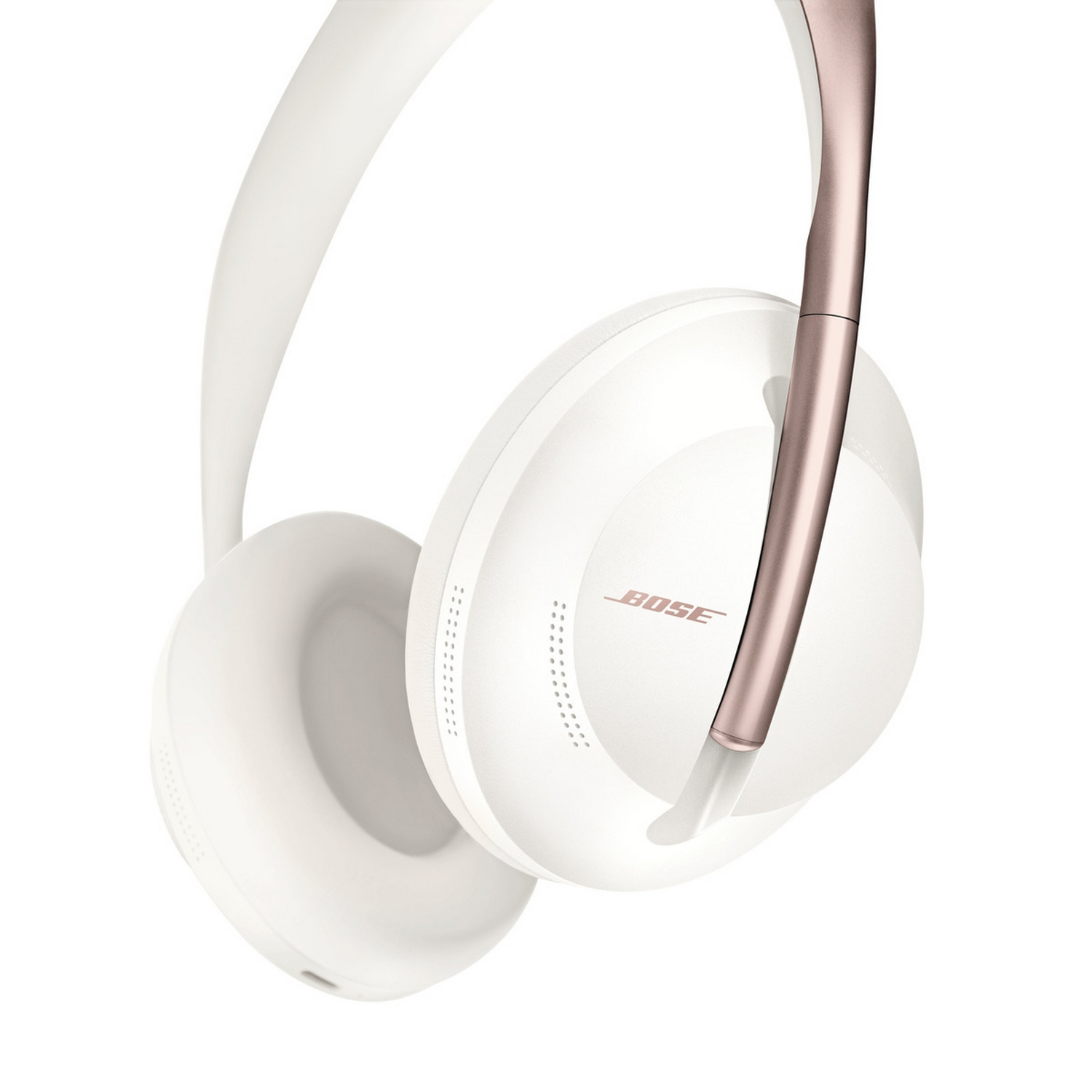 Auriculares Bose blancos y oro rosa, ligeramente angulados, con las copas visibles.