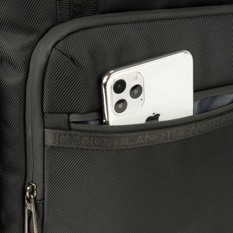 Gros plan d'un sac noir avec un téléphone argenté partiellement visible dans une poche.