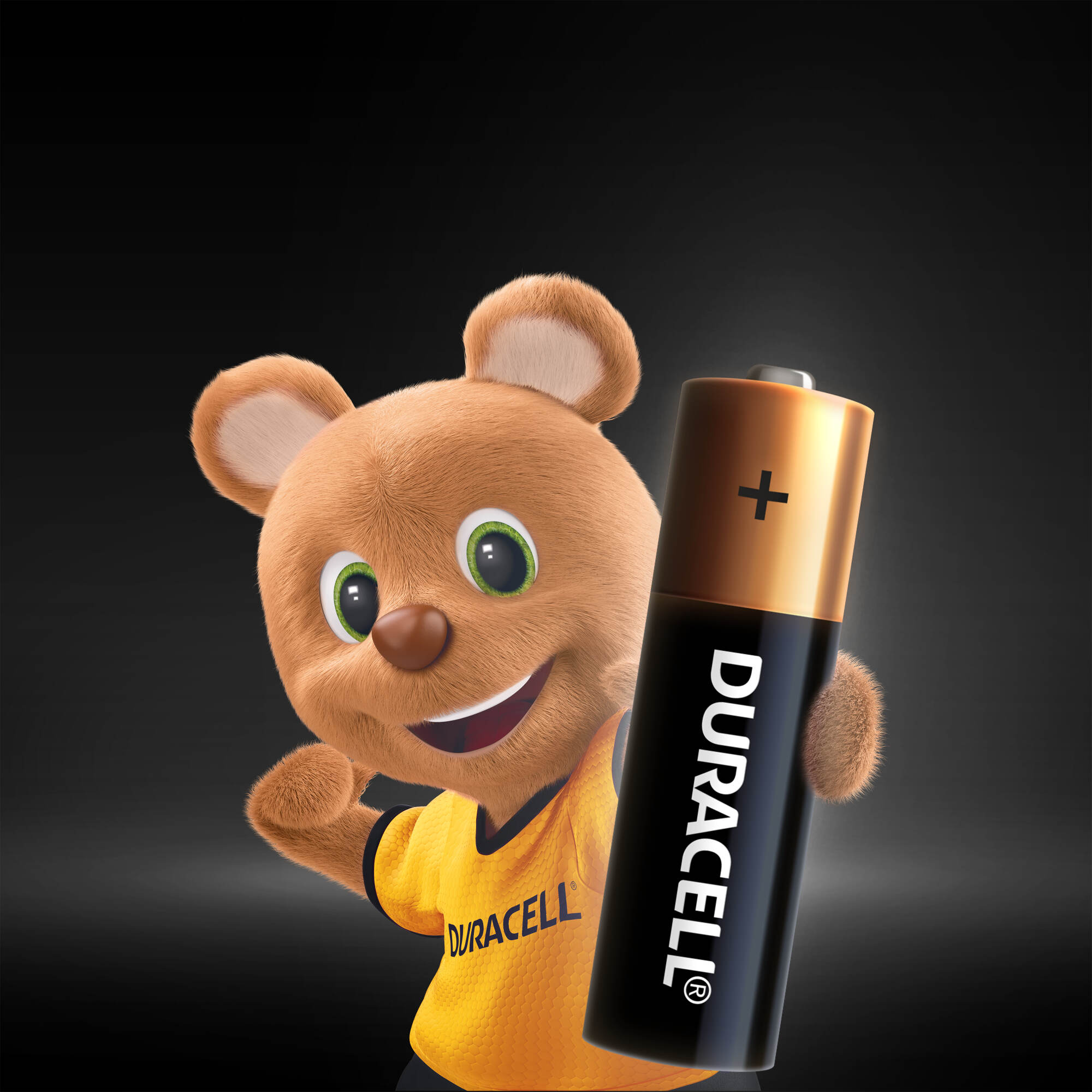 Duracell tişörtü giyen, gülen bir ayı maskotu tarafından tutulan Duracell pil.