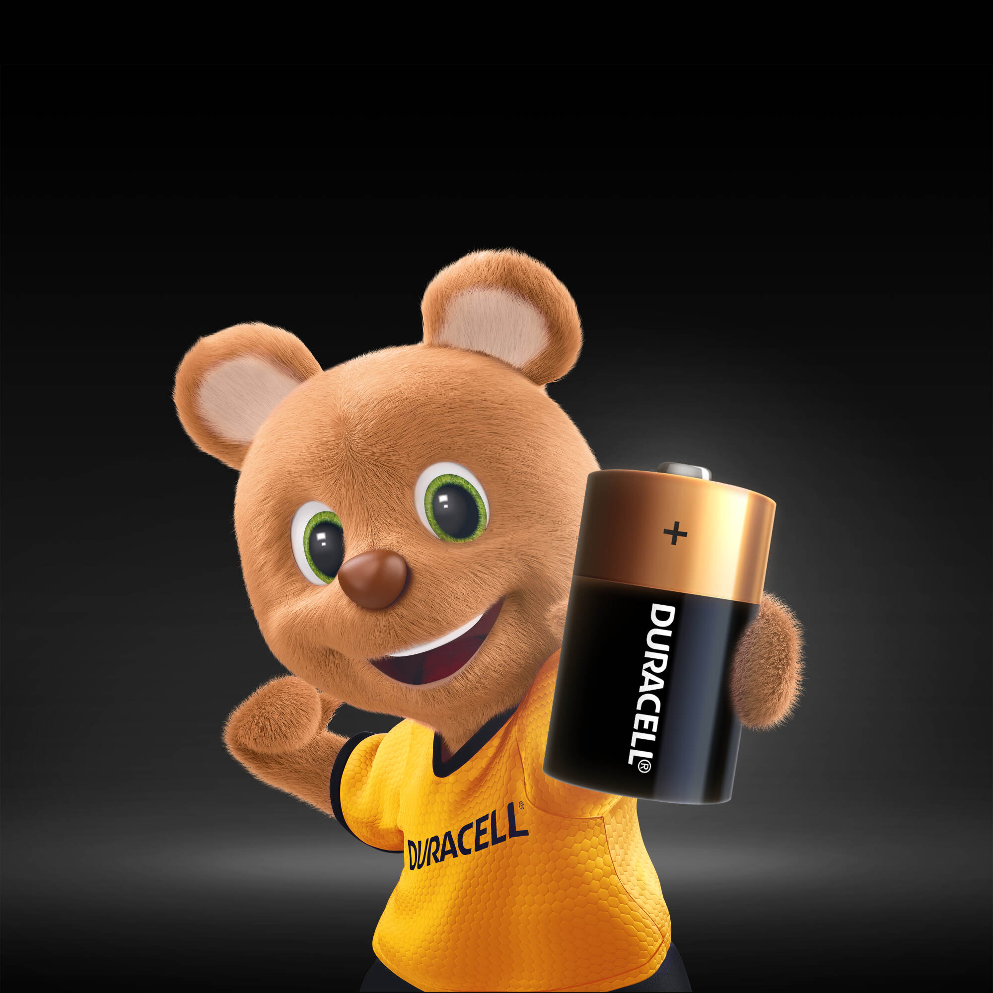 Duracell tişörtlü bir ayı maskotu, bir Duracell pili tutuyor.