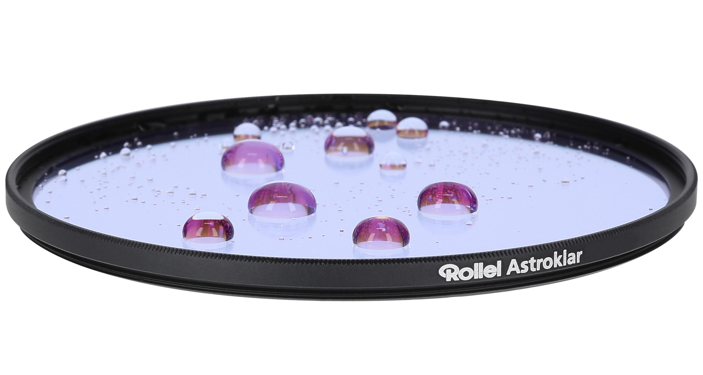 A round, black camera filter with water droplets. Some droplets are purple. The filter says 'Rollei Astroklar'.