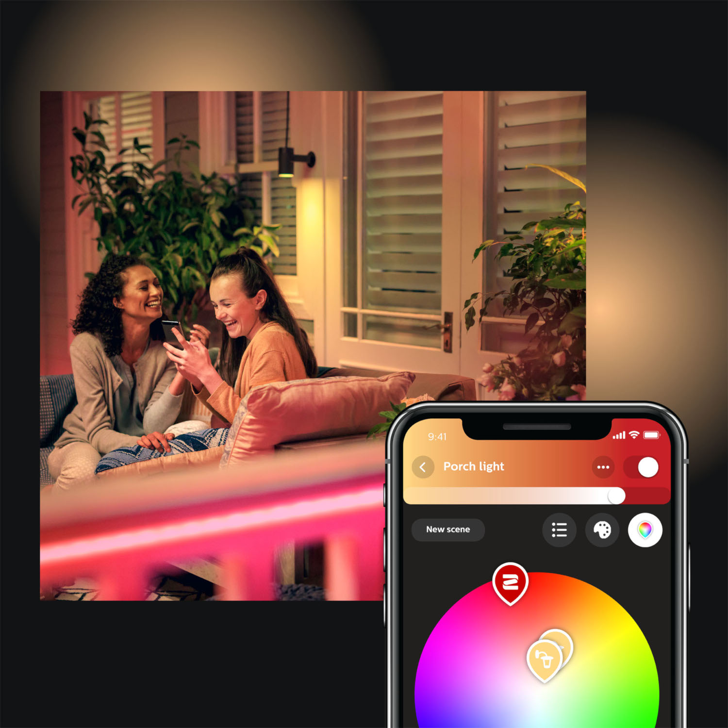 Two women on a porch look at a phone. A phone shows color options.