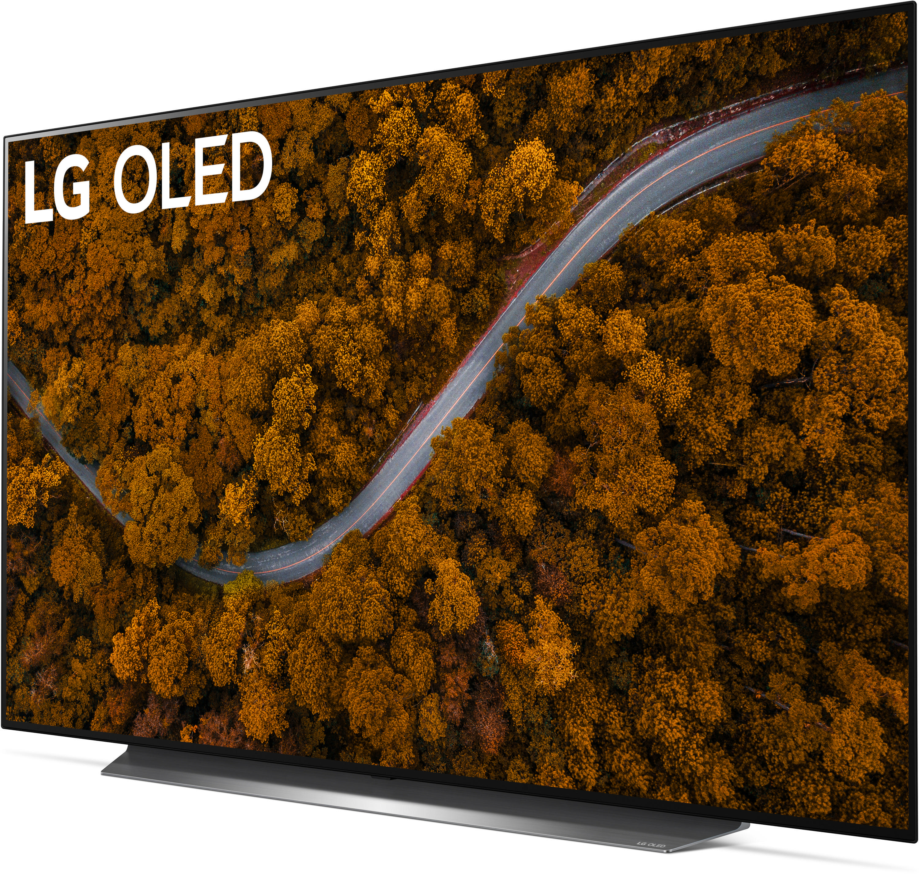 Ein LG OLED-Fernseher zeigt eine kurvenreiche Straße durch einen Wald mit herbstlich gefärbten Bäumen.