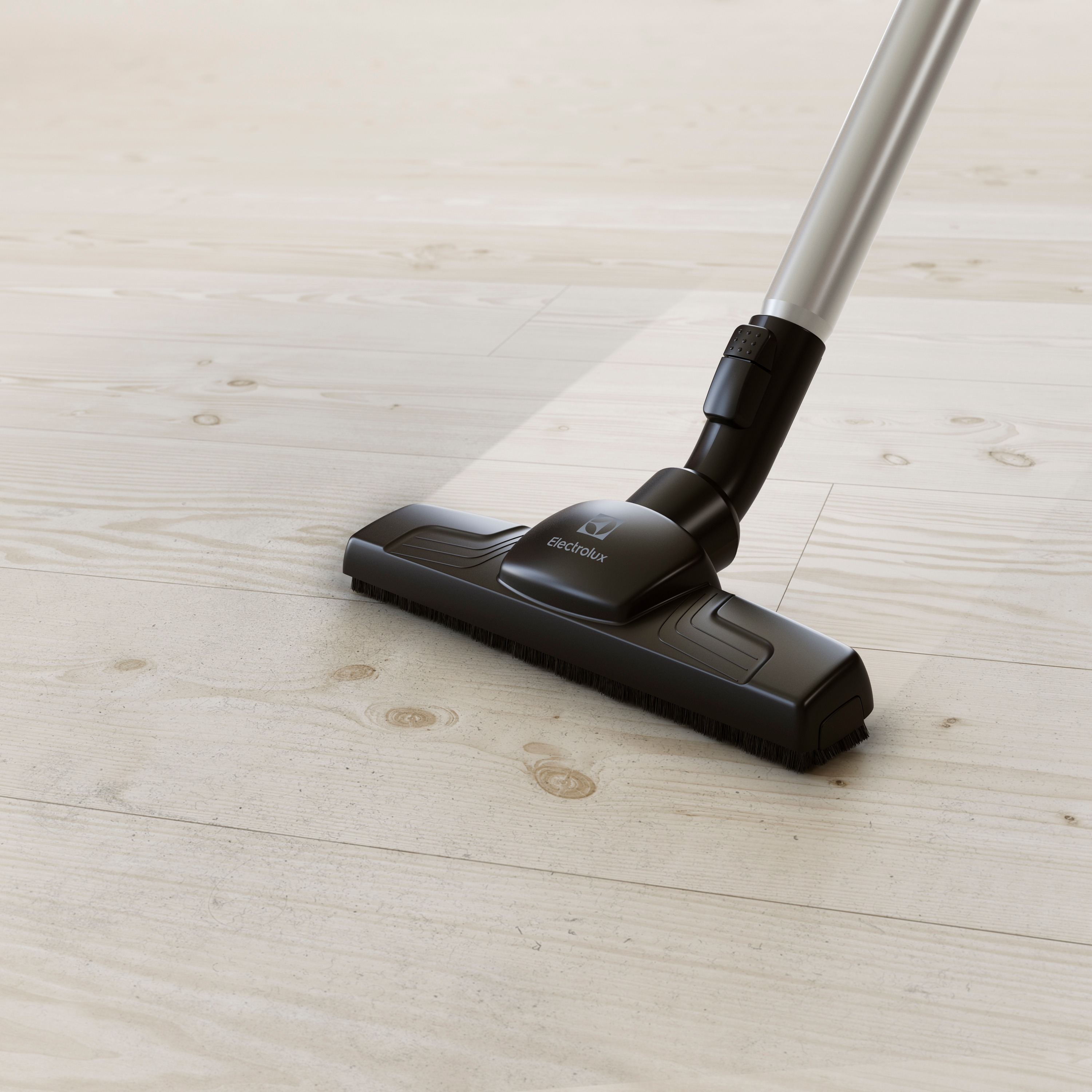 Una testina dell'aspirapolvere che pulisce un pavimento in legno, vista ravvicinata.