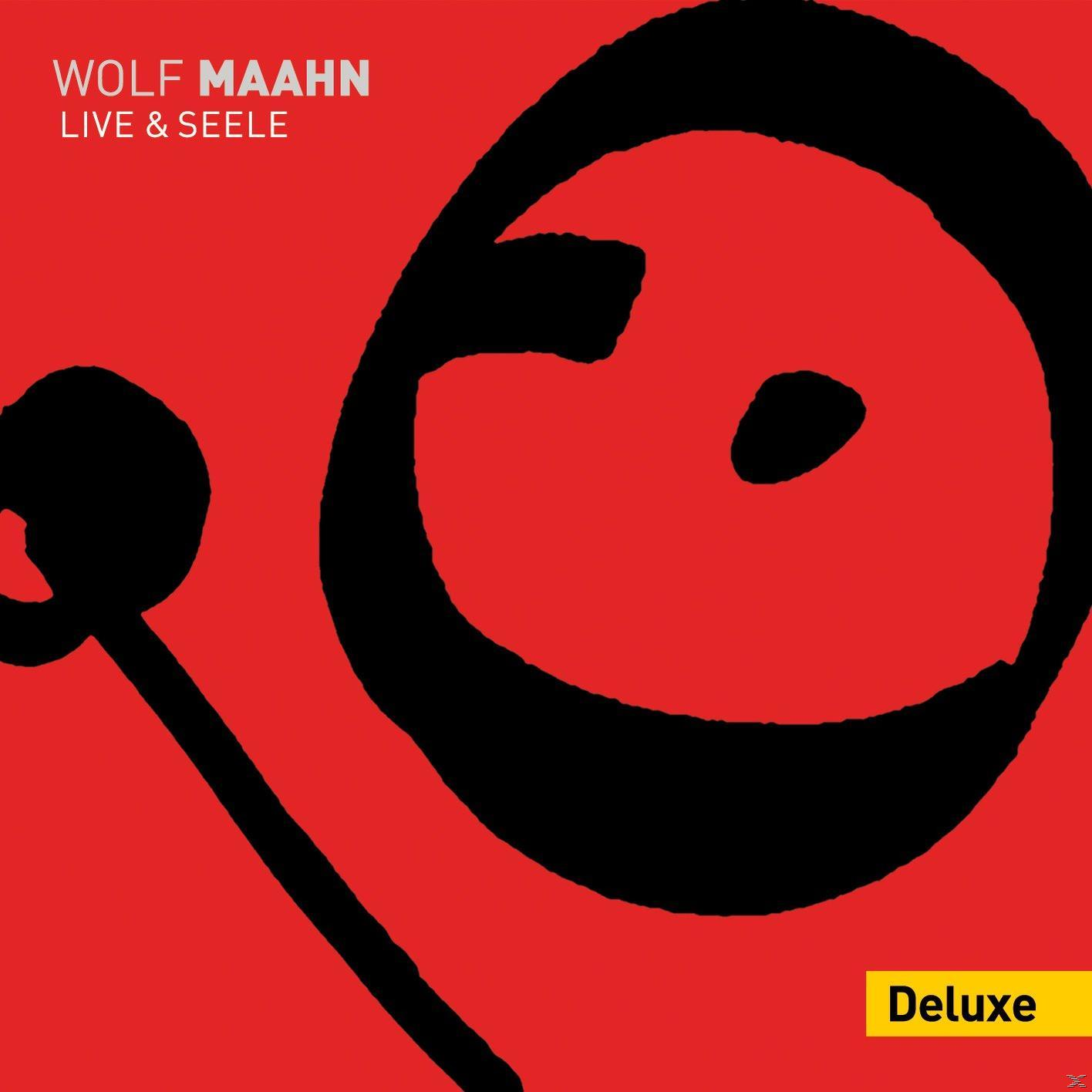 Albumcover mit rotem Hintergrund, schwarzem Kreis und Linie. Text: Wolf Maahn Live & Seele.