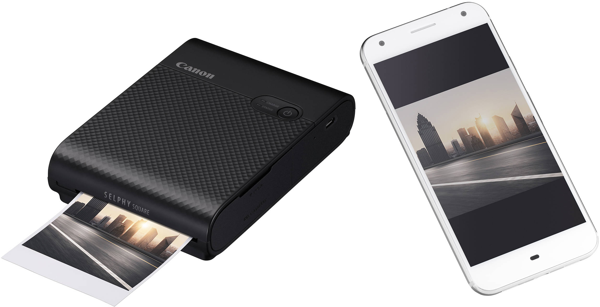 Imprimante Canon noire et un smartphone blanc affichant une image de ville.
