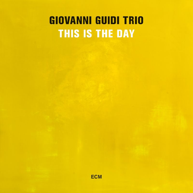 A Giovanni Guidi Trio This Is The Day című albumának borítója. Sárga háttér fehér szöveggel.
