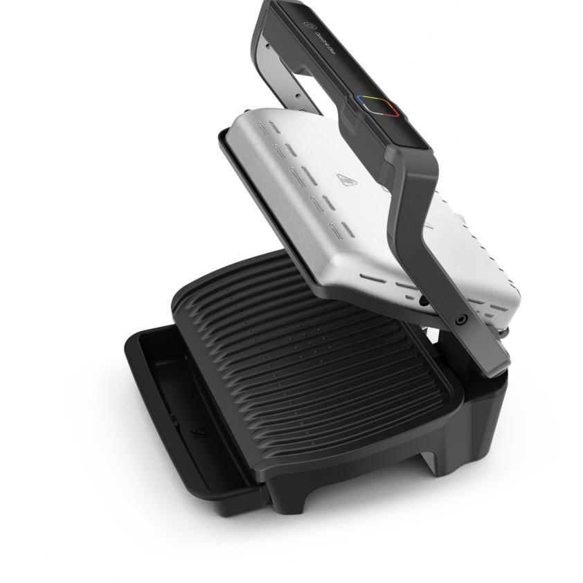Black and silver grill. Lid open. The grill is on a white surface.