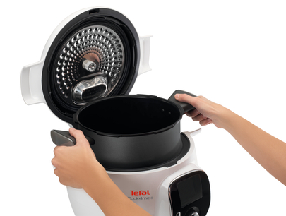 Kezek nyitnak egy fehér-fekete Tefal Cook4me+ multikuktát.