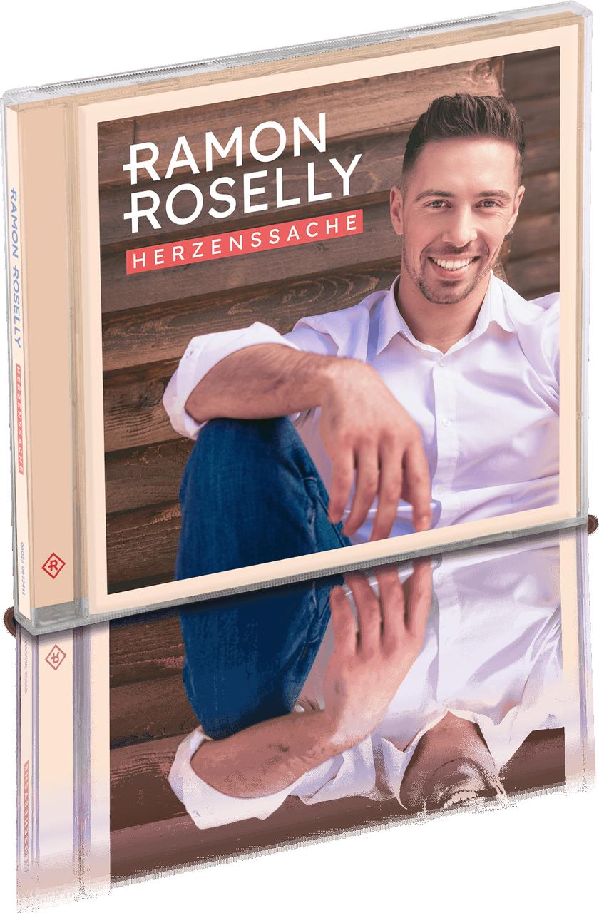 Buchcover mit einem Mann. Titel: Ramon Roselly, Herzenssache. Spiegelung im Glas.
