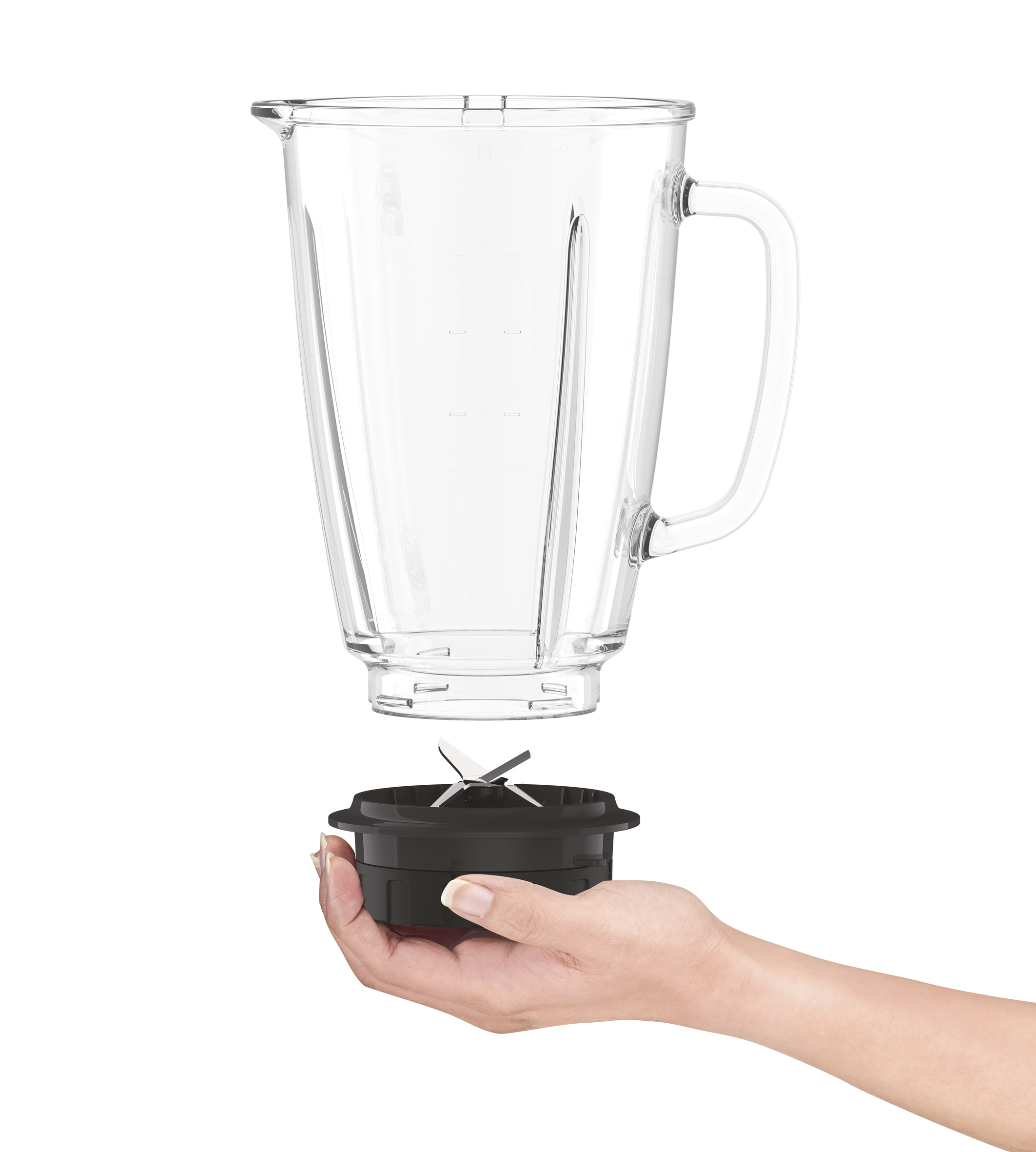A hand holds a blender base with blades. The empty pitcher is above it.
