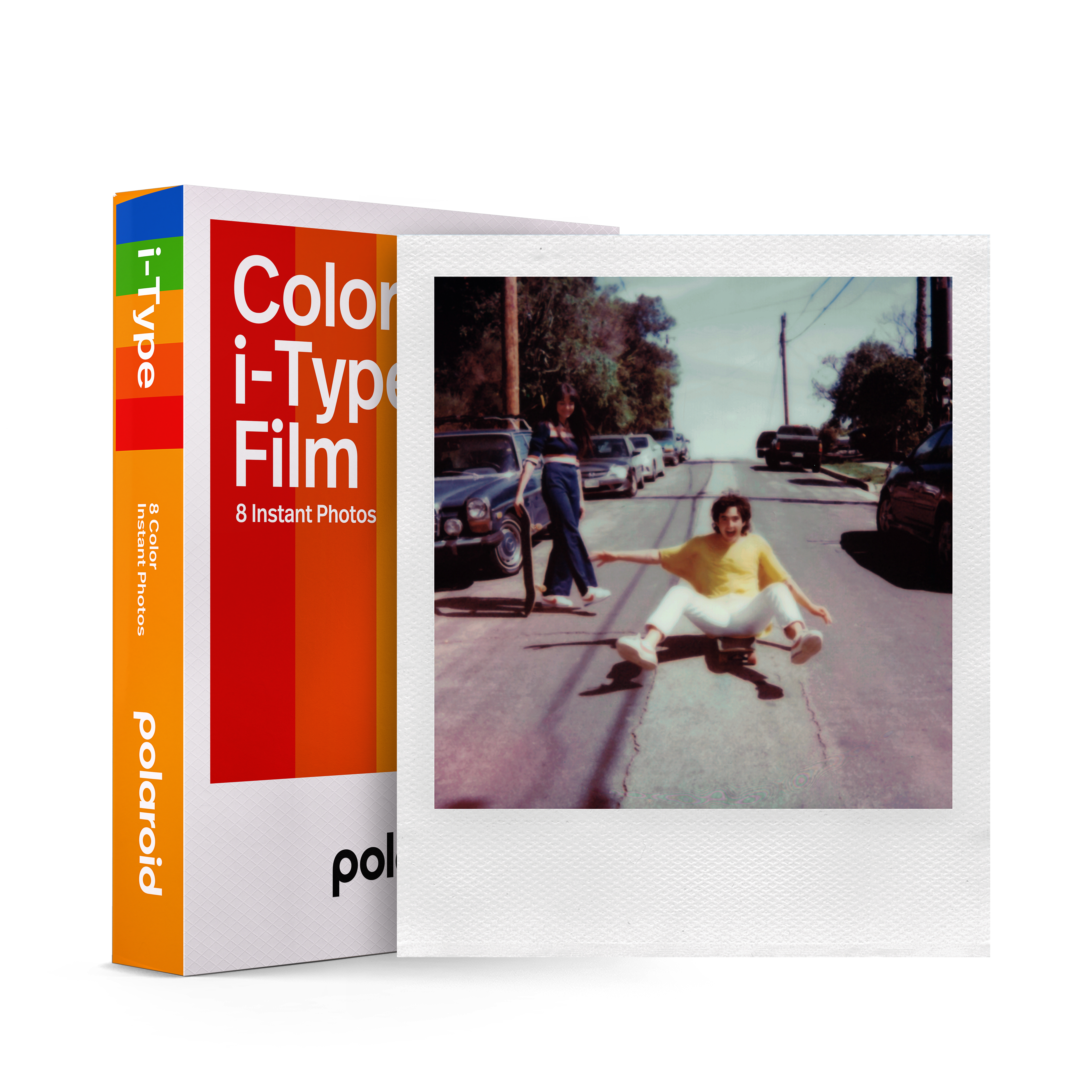 Polaroid i-Type film box and photo with people on a road, a car and a dog.