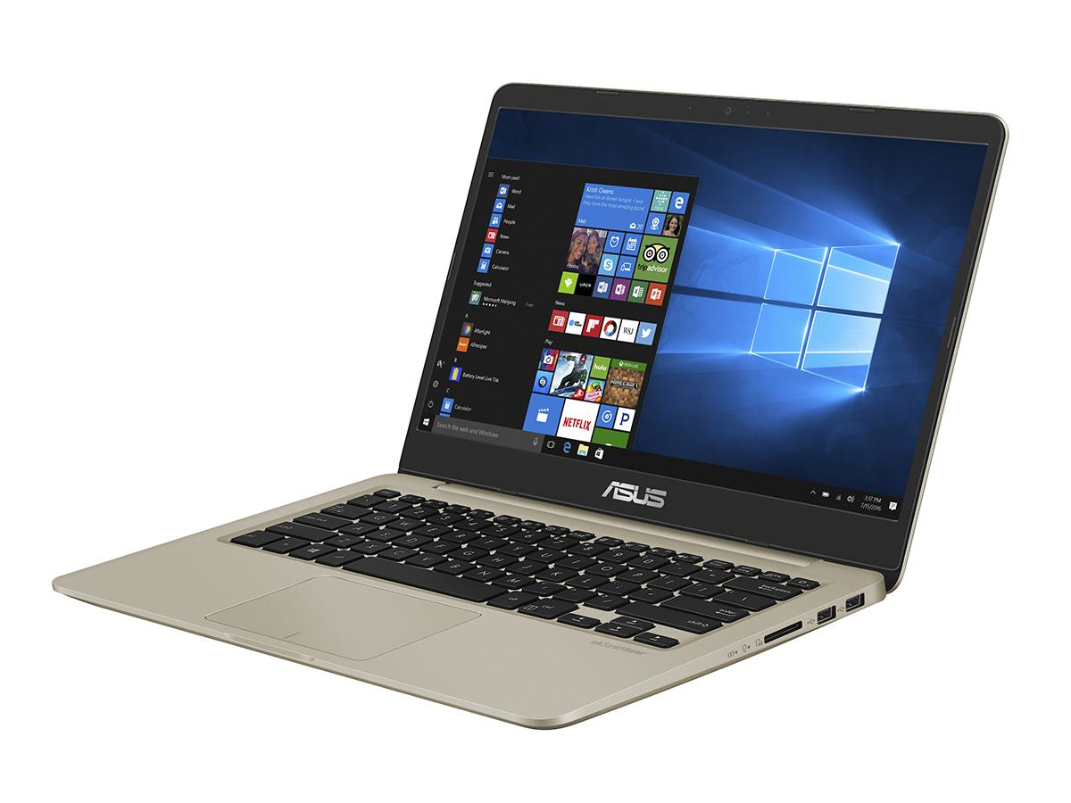 Ein goldener Asus Laptop steht offen auf einer weißen Oberfläche und zeigt den Windows 10 Startbildschirm.
