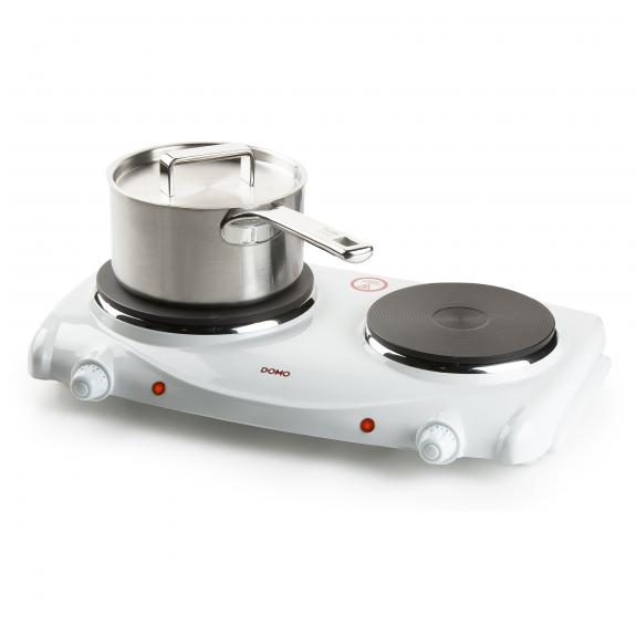 A white double electric hotplate with a covered pot on it.