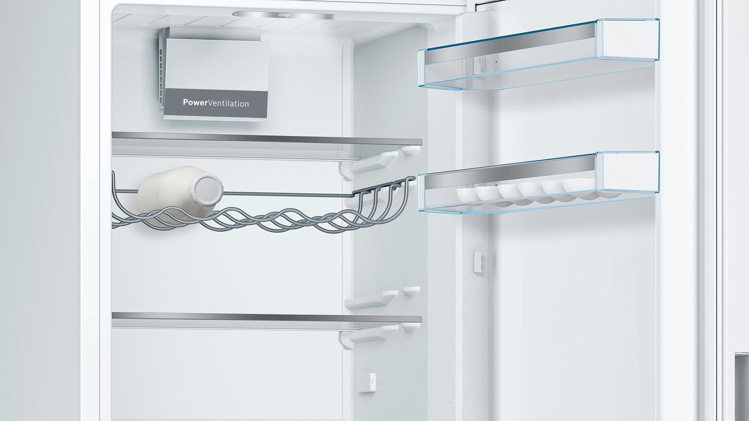 Open refrigerator interior. Shelves, egg holder, and a ventilation system are visible.