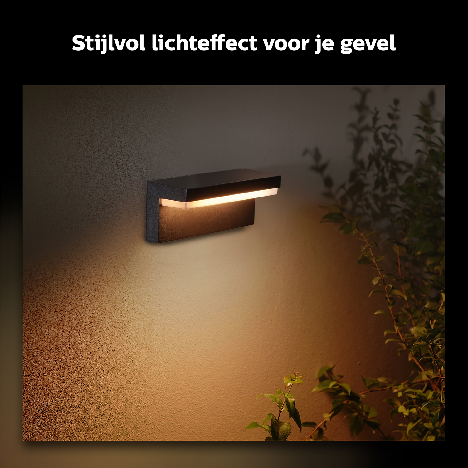 A black wall lamp with a rectangular shape, emitting warm light, mounted on a textured wall.