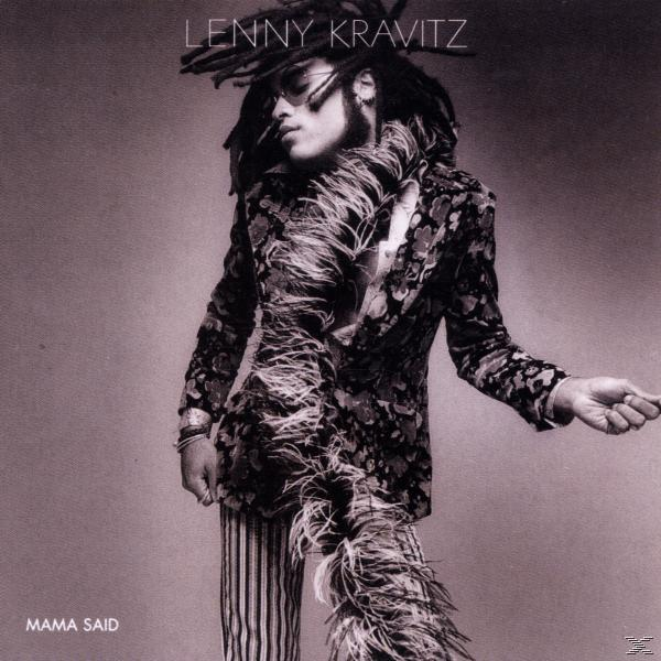 Lenny Kravitz virágos zakóban és csíkos nadrágban. Napszemüveget és tollboa-t visel. A 'Mama Said' album címe látható.