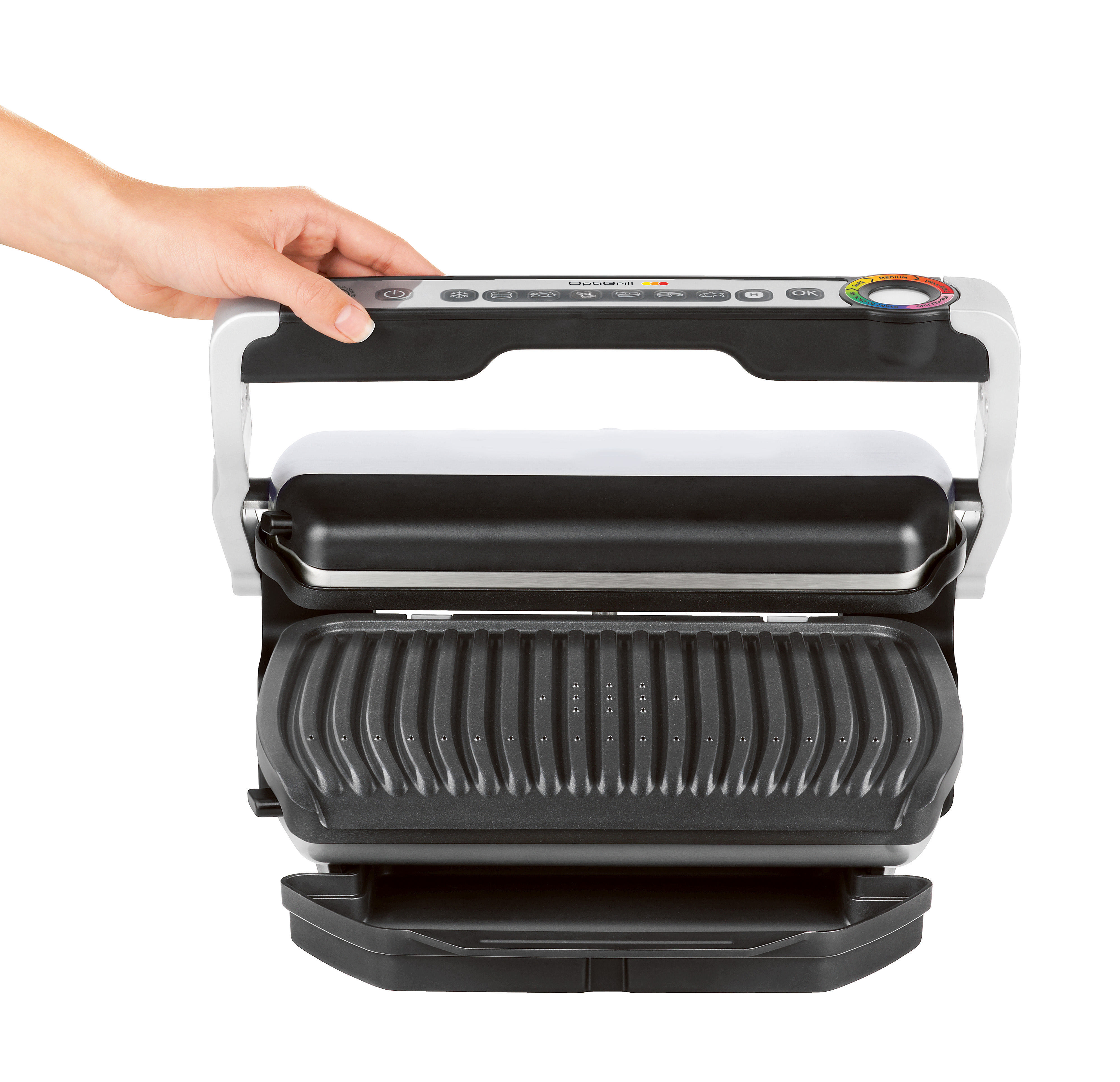 Hand hält geschlossenen Elektrogrill, Draufsicht. Auf weißer Oberfläche.