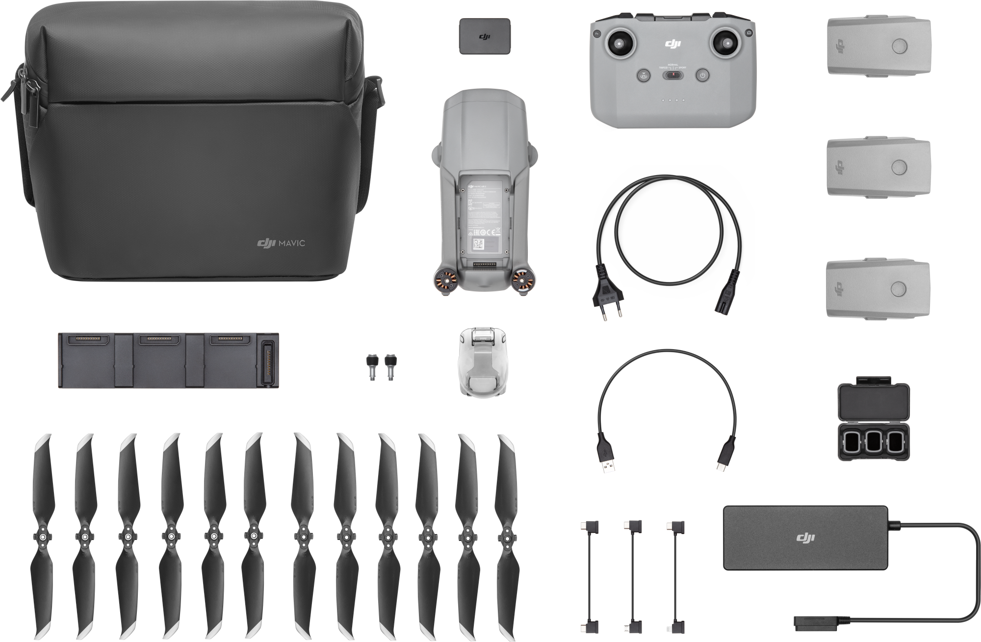 Drohnen-Kit, verschiedene Komponenten auf schwarzem Untergrund. Artikel sind Drohne, Fernbedienung, Batterien und Propeller.