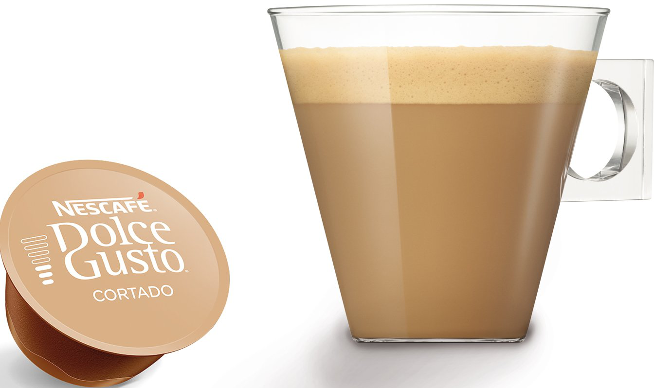 Bicchiere di caffè con schiuma e una capsula di caffè Dolce Gusto Cortado.