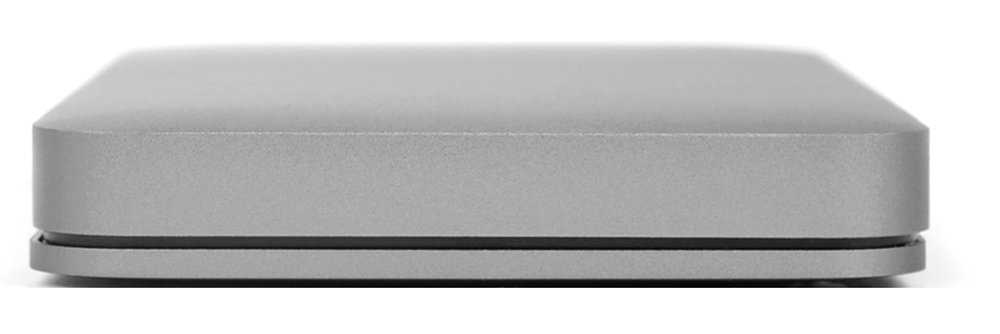 A side view of a gray, rectangular device with rounded edges, on a white surface.