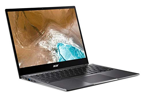 Un portátil plateado con teclado negro y una pantalla que muestra un paisaje azul.