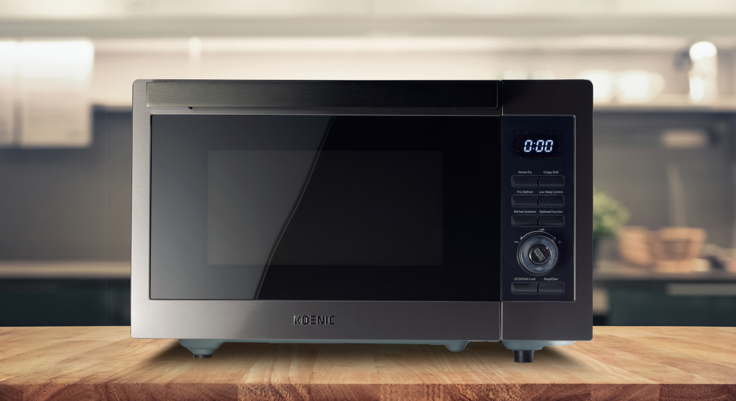Microwave oven on a wooden table with a blurred kitchen background.