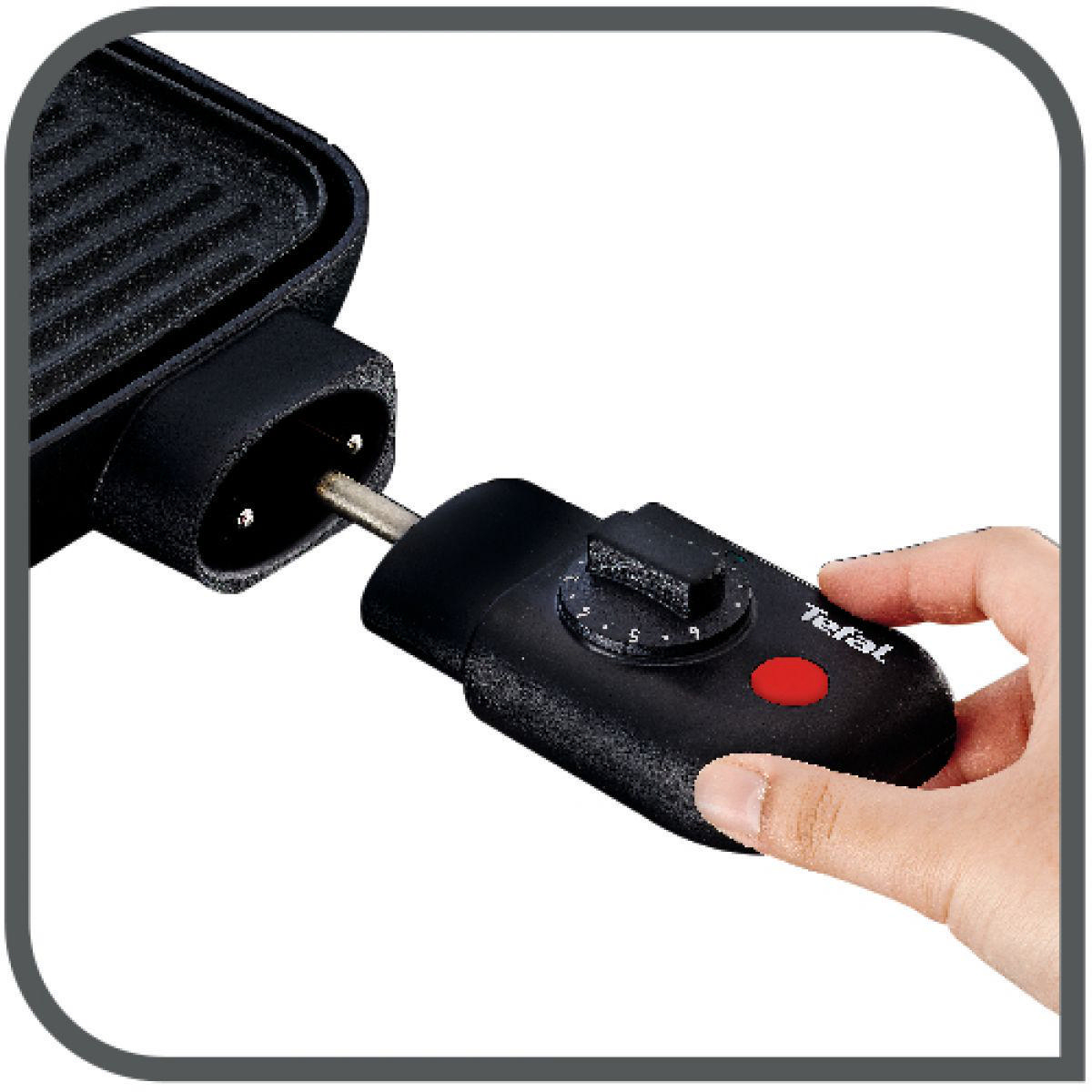 Hand, die ein schwarzes Netzkabel an eine schwarze Tefal-Grillplatte anschließt.