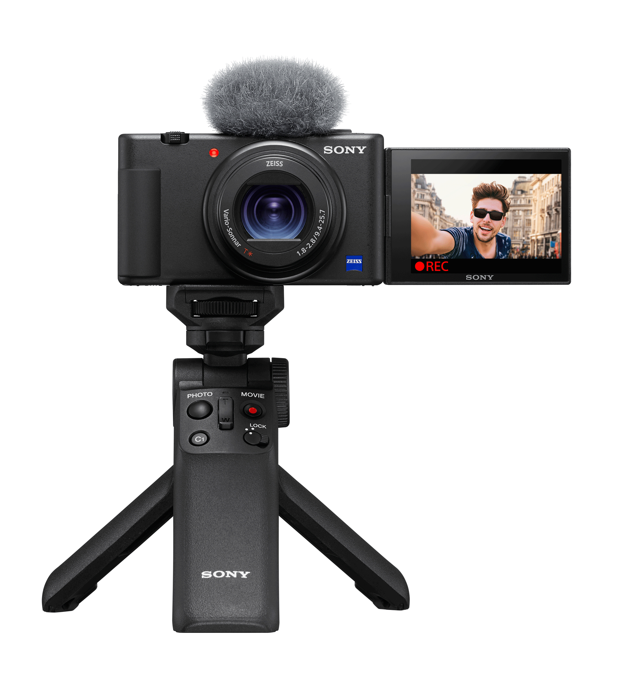 Black Sony camera with a microphone, facing right. The screen shows a man recording a video.