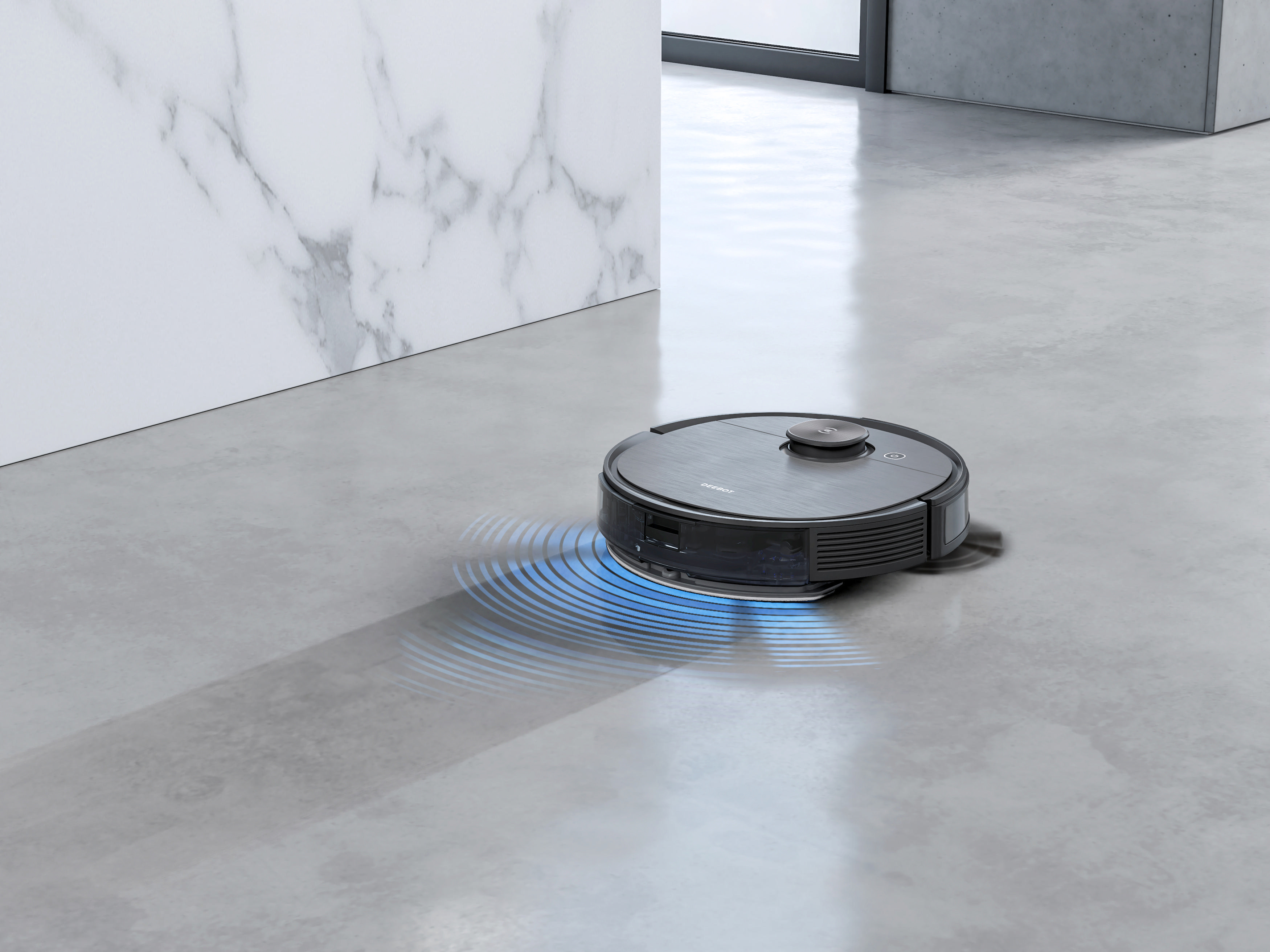 Ein Roboter-Staubsauger auf einem grauen Boden, mit blauen Lichtstrahlen, die von unten emittieren.