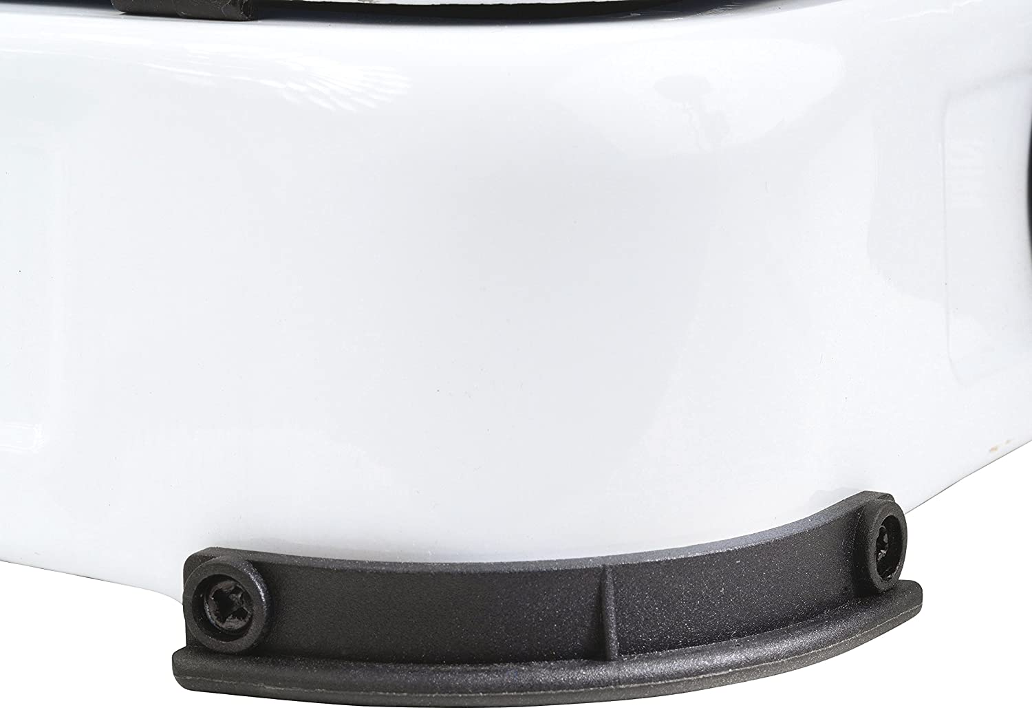A close-up of the white bottom of a product with black rubber feet is shown.