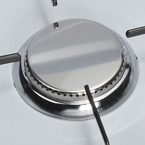 Close-up of a stove burner. It is silver and has small holes around its edge.