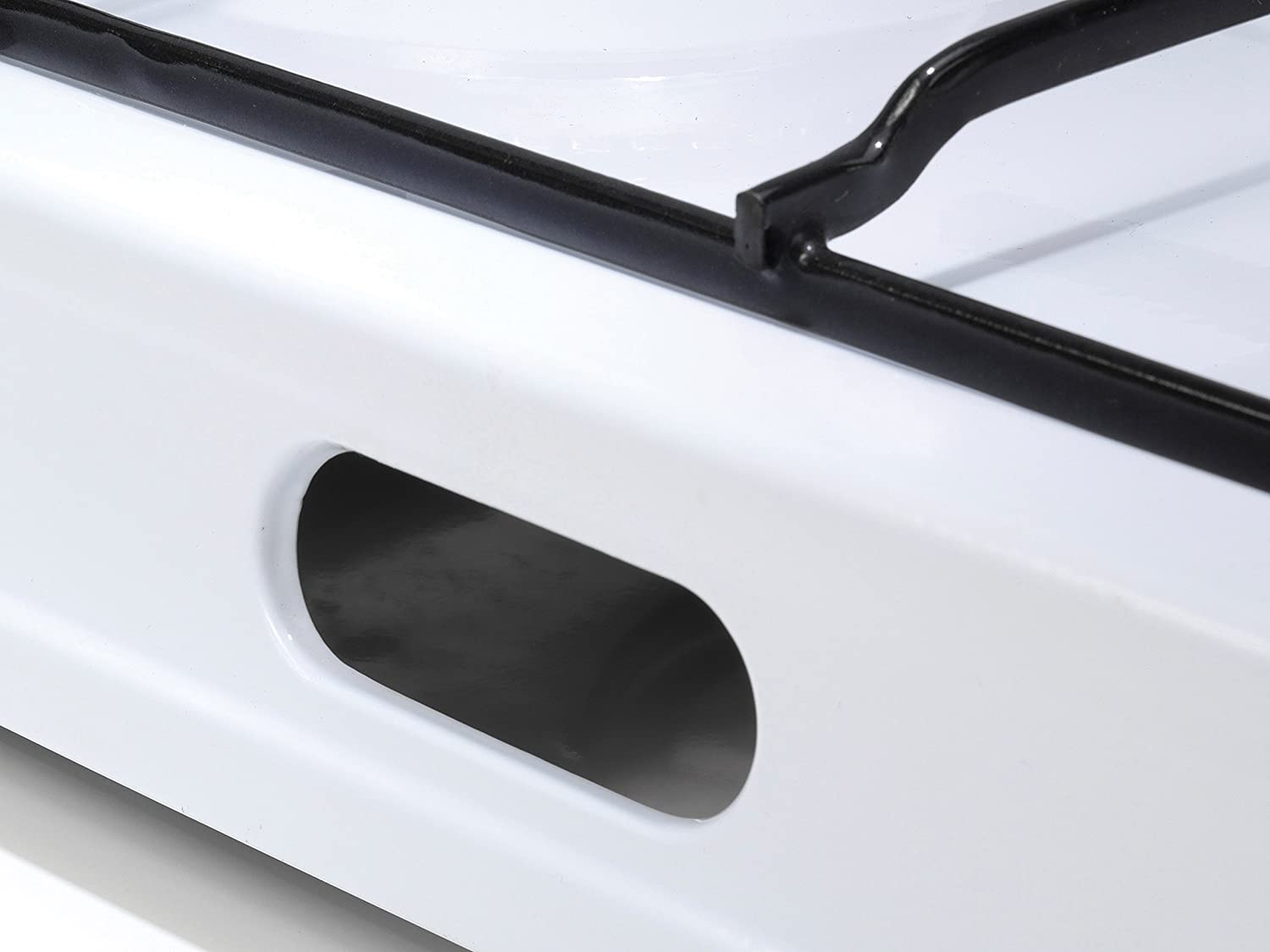 White stove with a black edge and a hole for the gas.